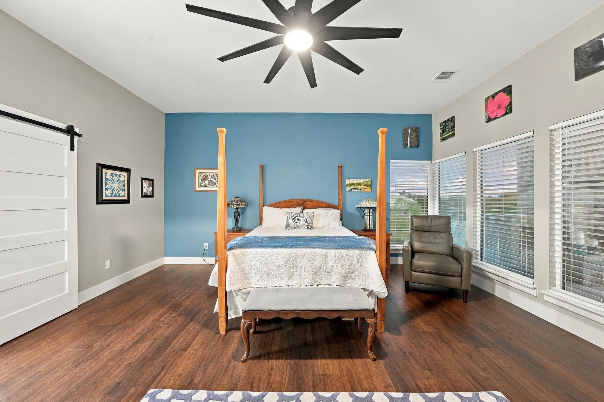 Primary bedroom with a sliding barn door entry to ensuite bathroom