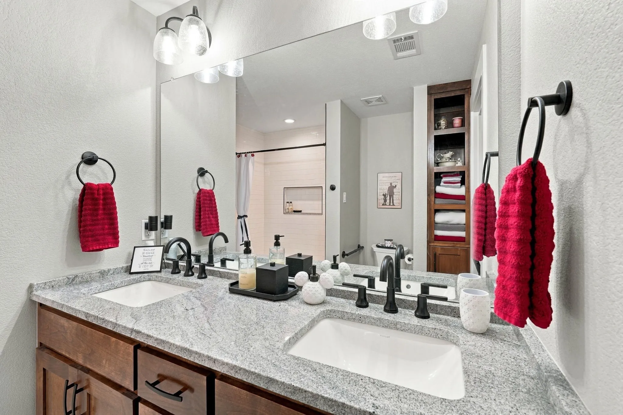 Guest bathroom with dual sinks and custom cabinets
