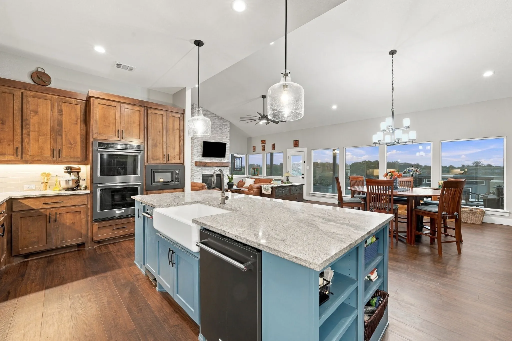 Large kitchen island with farm sink, dishwasher, and trash compactor. All Kitchenaid appliances