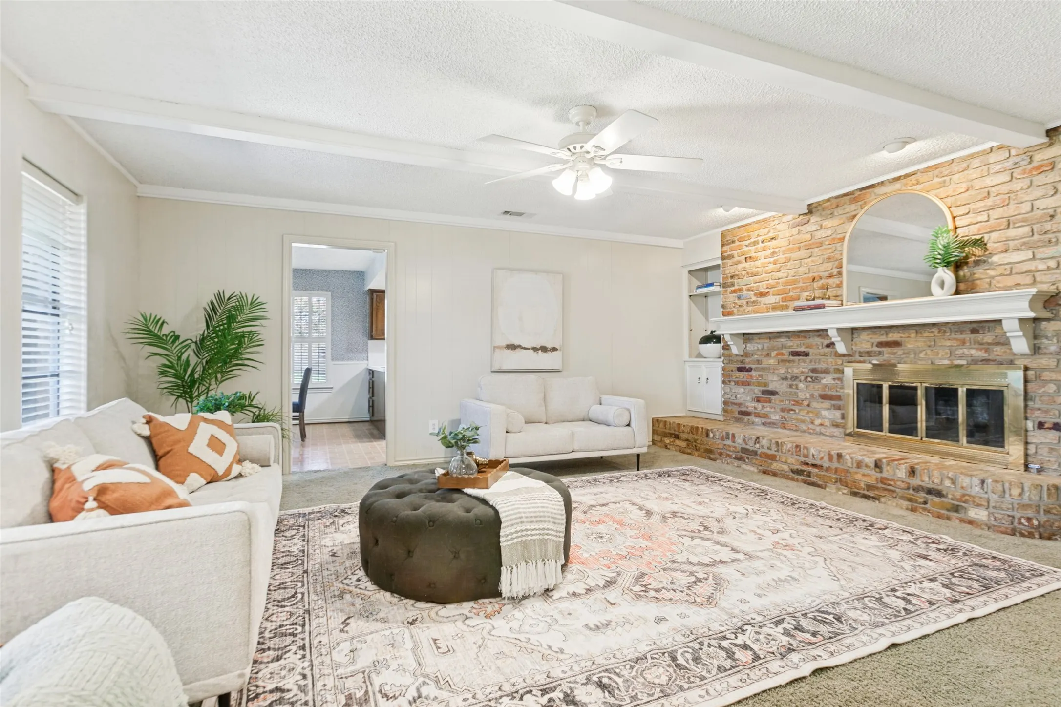 915 Grinnell Dr. - Spacious den featuring windows overlooking the back porch, a beautiful brick fireplace with built-in storage, and an attached walk-in closet providing exceptional additional storage