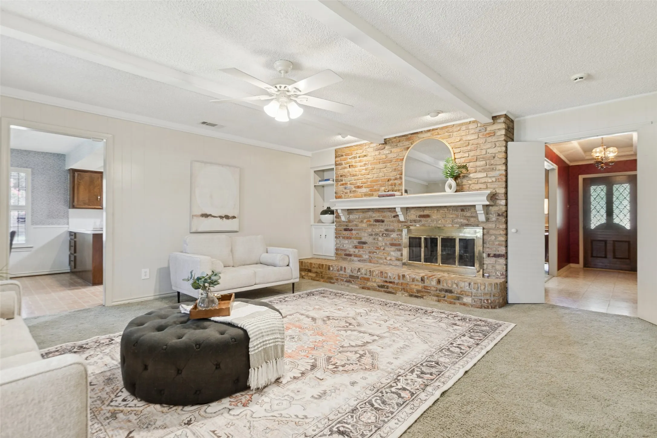 915 Grinnell Dr. - Spacious den featuring windows overlooking the back porch, a beautiful brick fireplace with built-in storage, and an attached walk-in closet providing exceptional additional storage