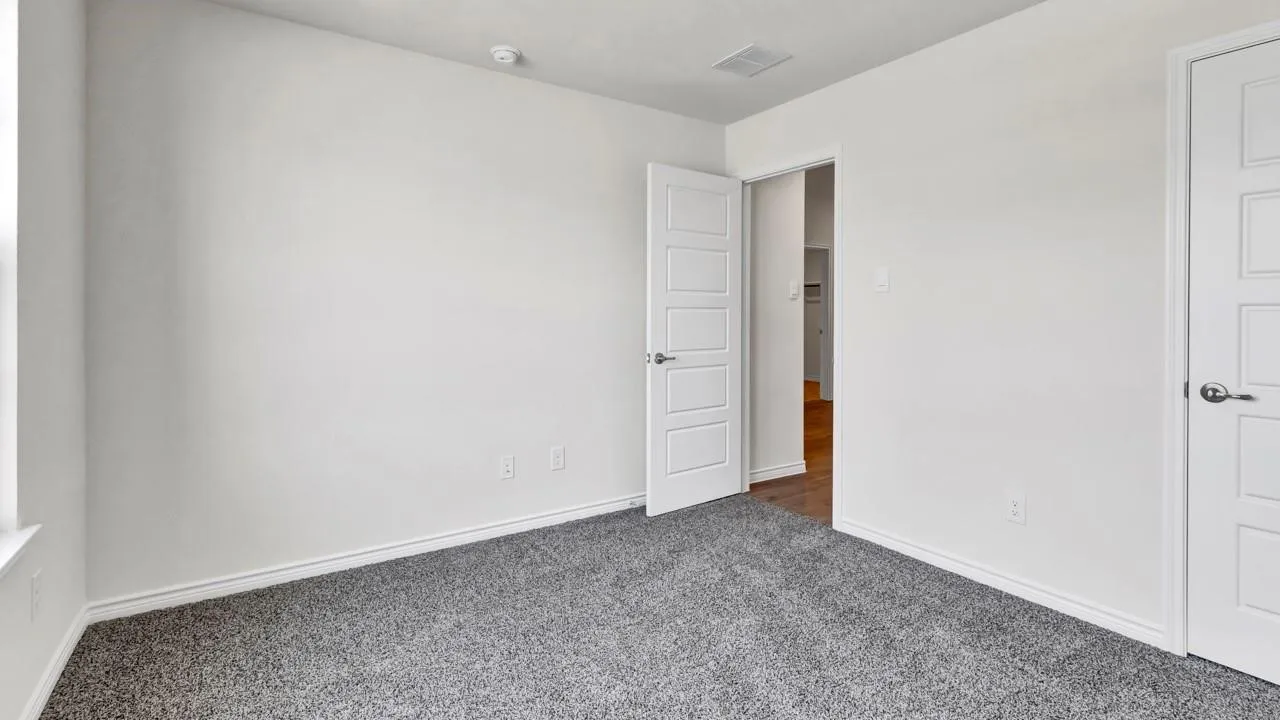 Light-toned walls complement the gray carpeting