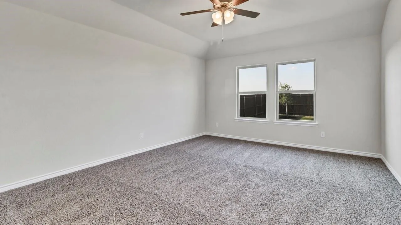 Spacious room with plush carpeting and light-toned walls