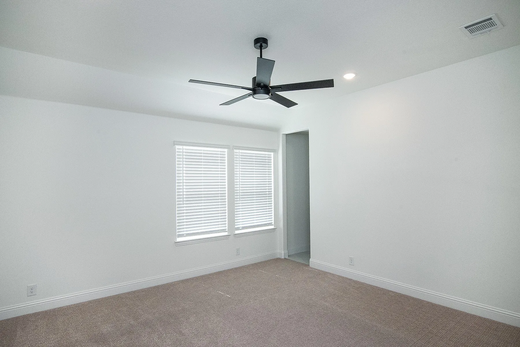 Recessed lighting, ceiling fan, white walls, carpet flooring, and window blinds