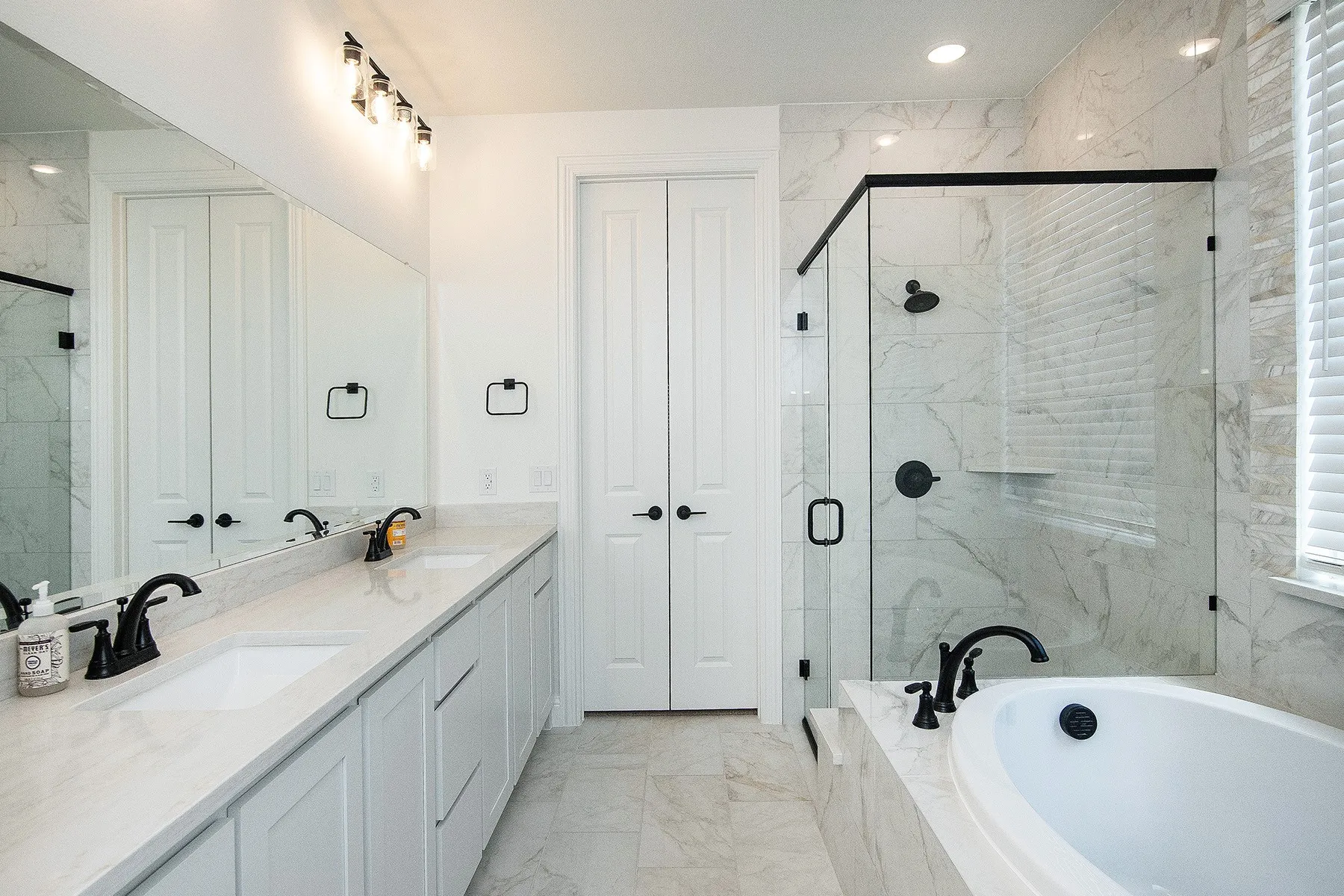 Dual vanity with undermount sinks and light-toned countertops