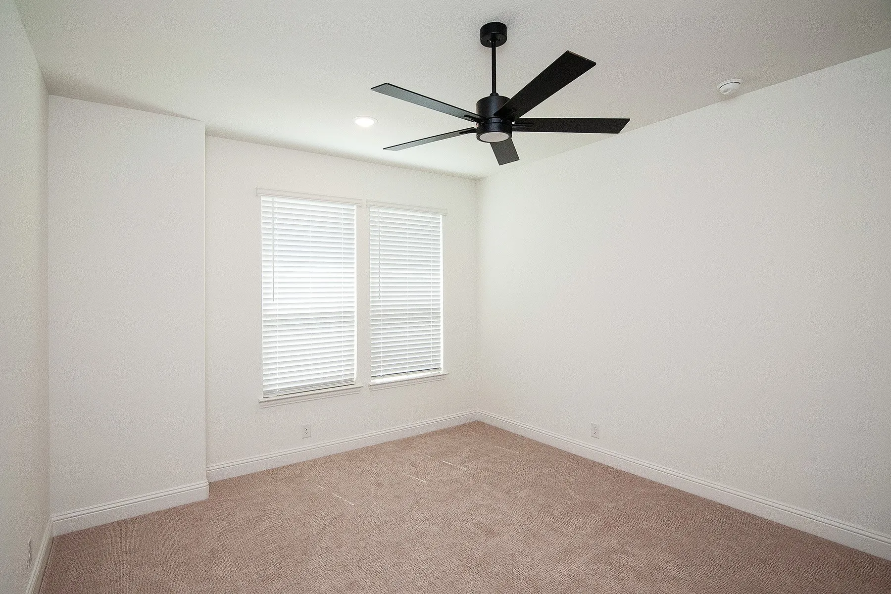 Neutral paint palette with carpet flooring, window blinds, and a ceiling fan with integrated lighting