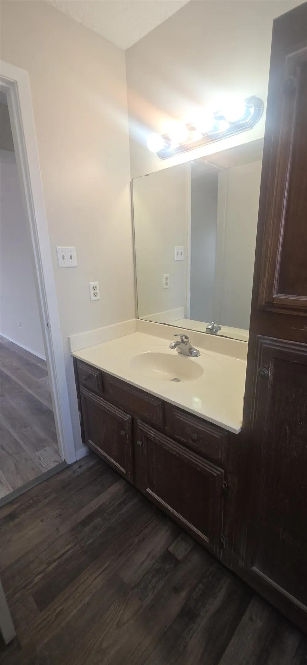Vanity featuring an integrated sink, polished chrome faucet, and a light-toned countertop