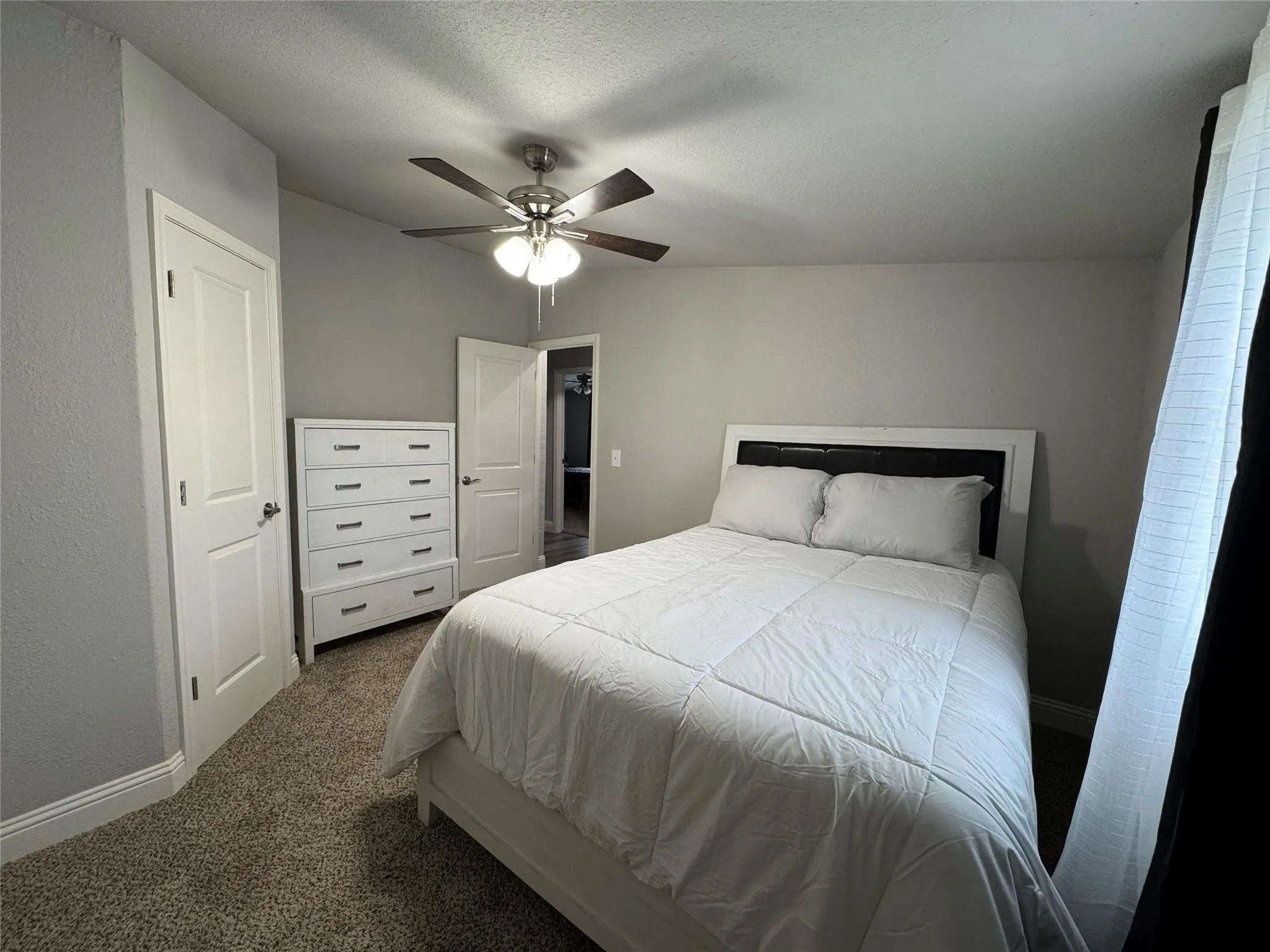 Bedroom five with full size bed and dresser.
