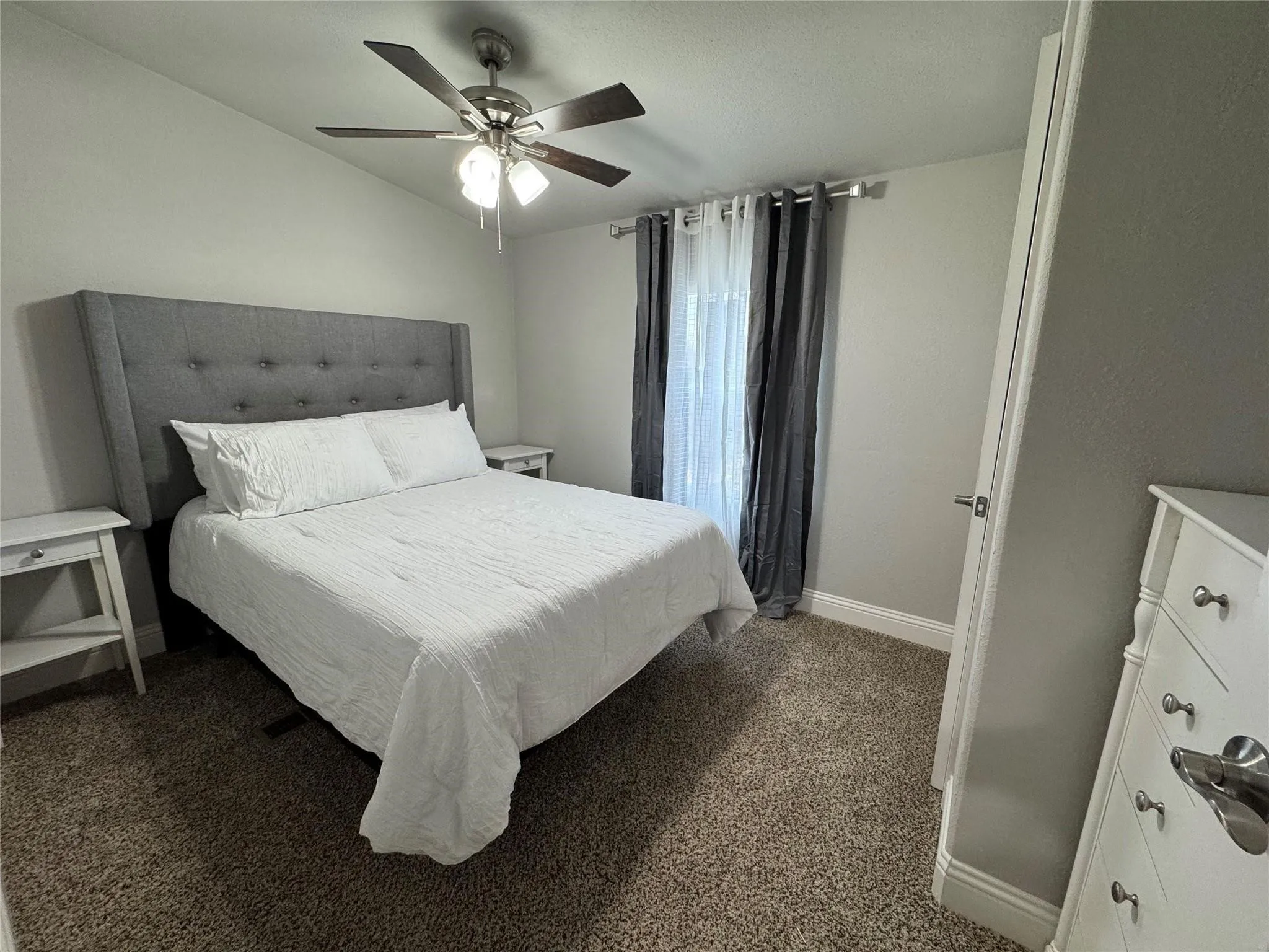 Bedroom two with full size bed, nightstands and a dresser.