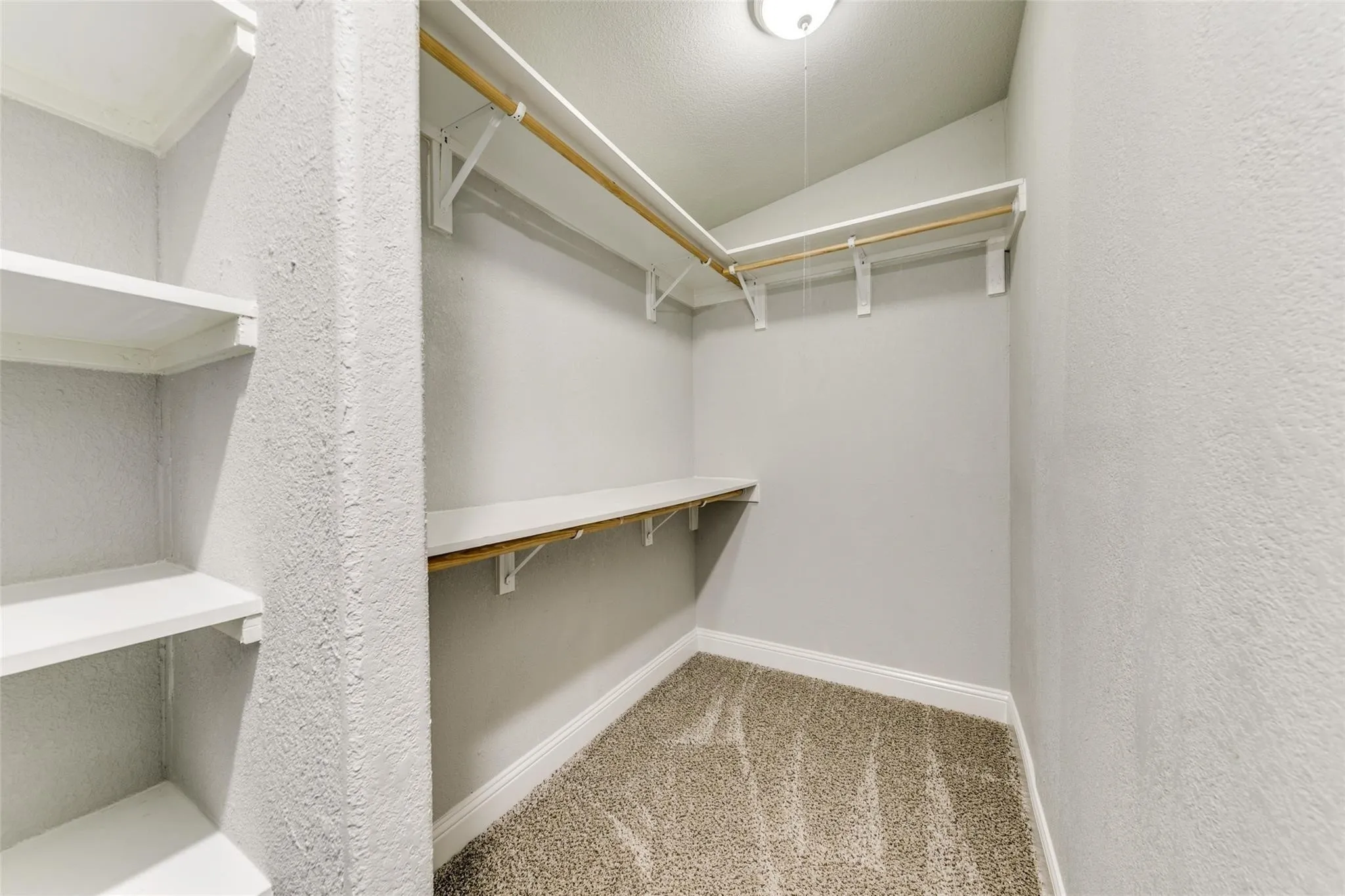 Master Closet with built in wood shelving.