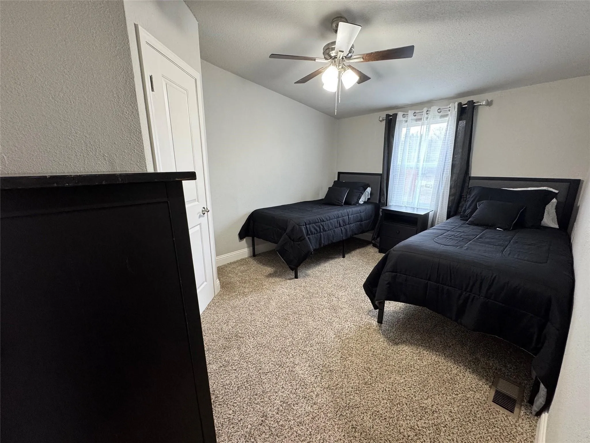 Bedroom four with two twin beds, nightstand and dresser.