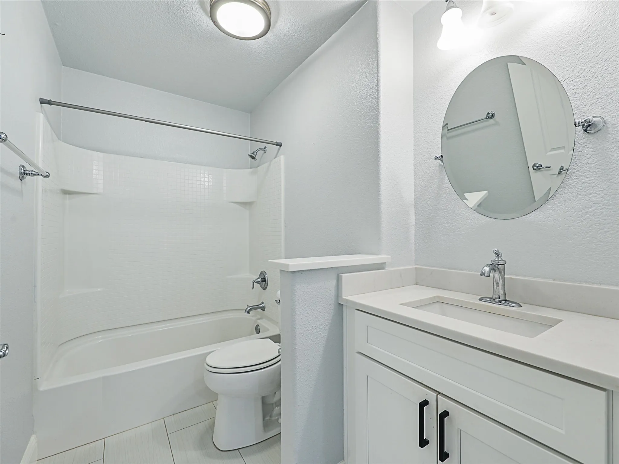 Full bathroom featuring bathtub / shower combination, tile floors, vanity