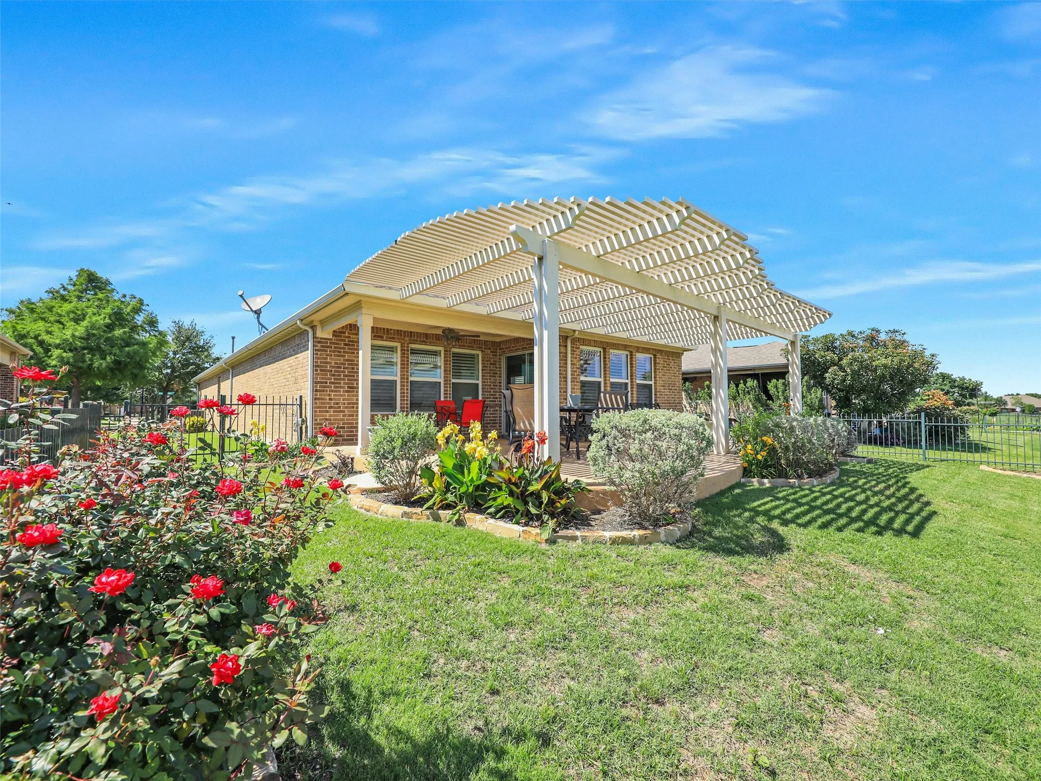 Back of property featuring a pergola and a yard
