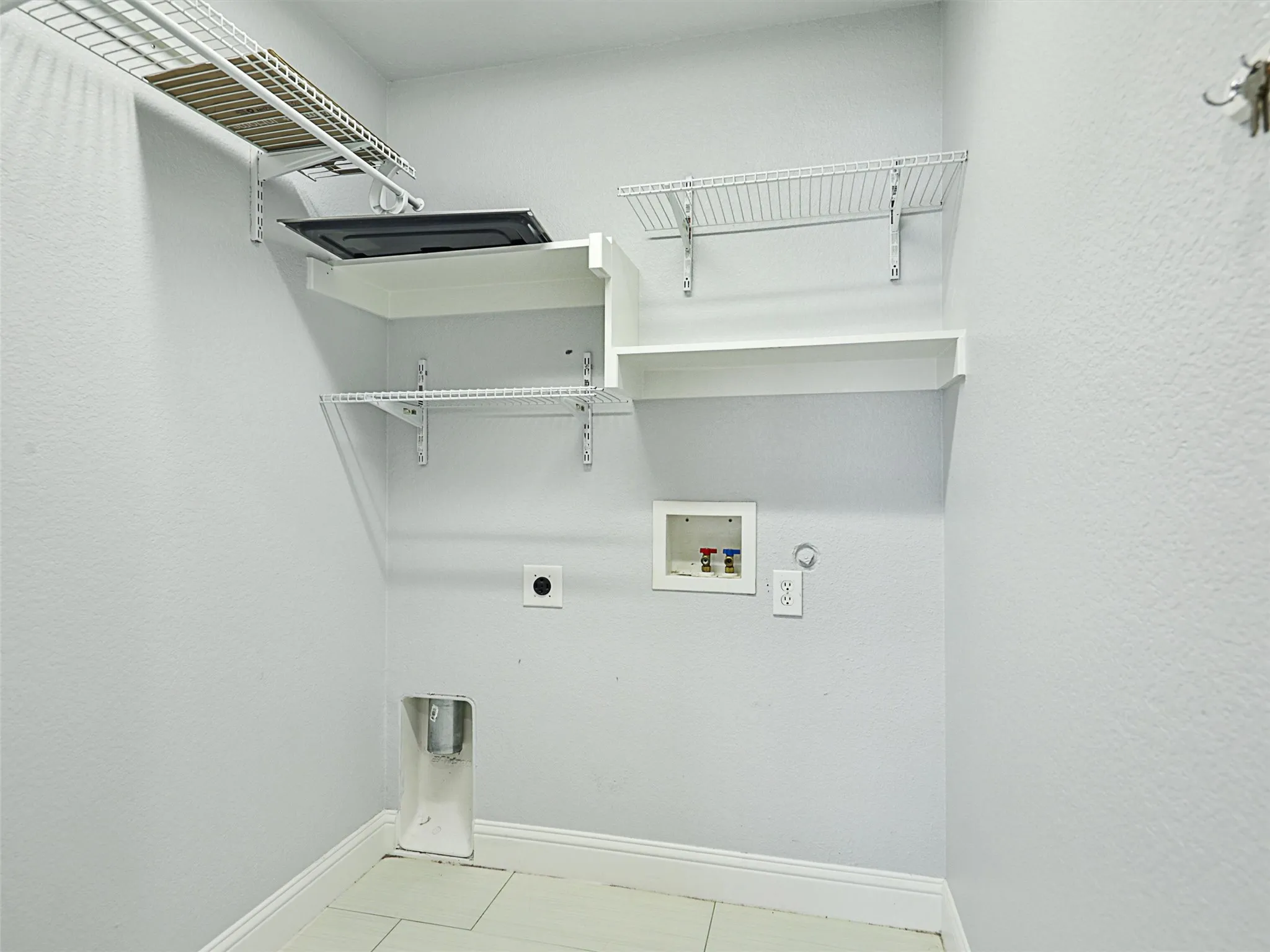Laundry room featuring tile floors, gas dryer hookup, washer hookup, and electric dryer hookup