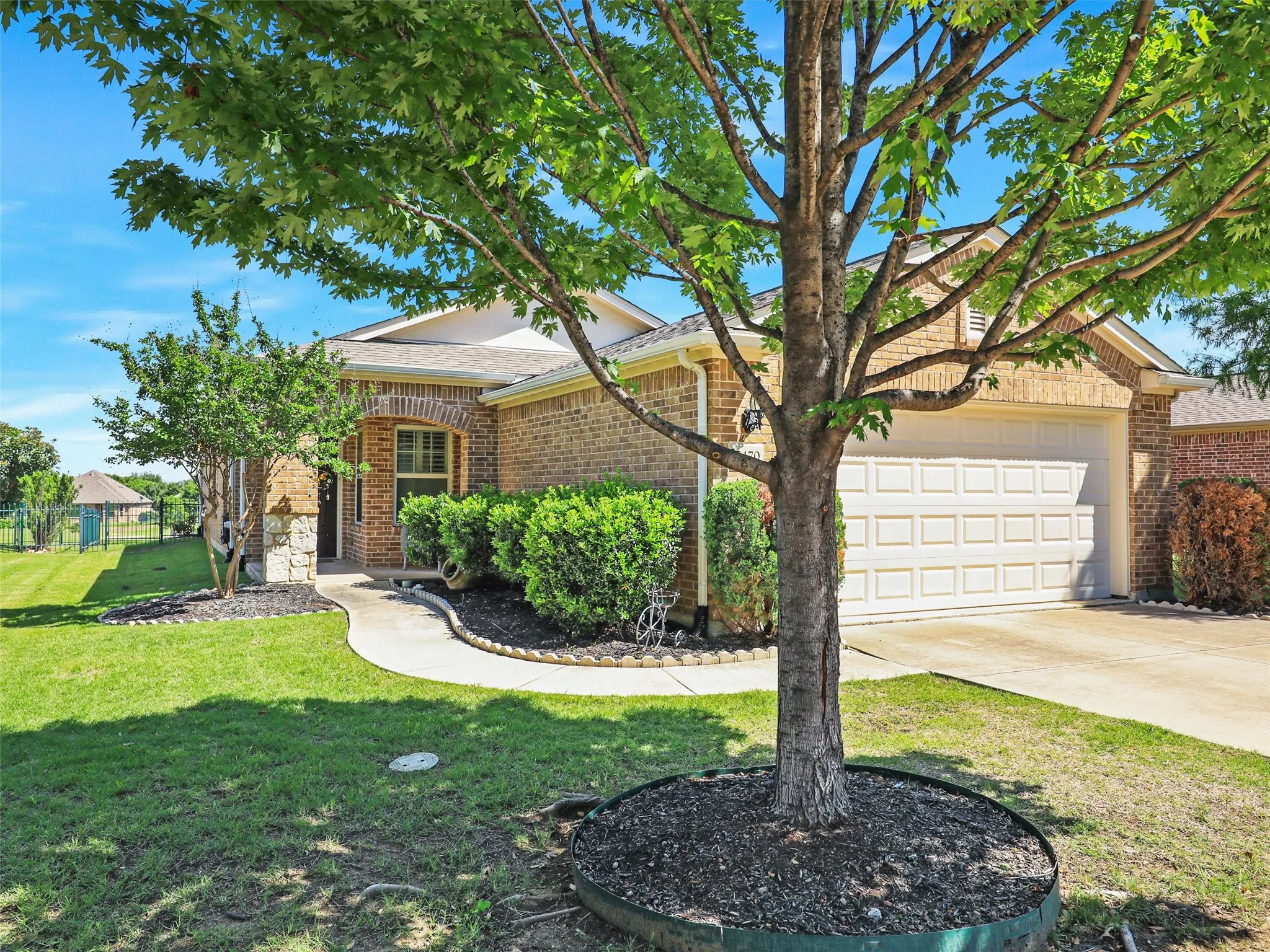 View of front of home featuring a front yard and a garage
