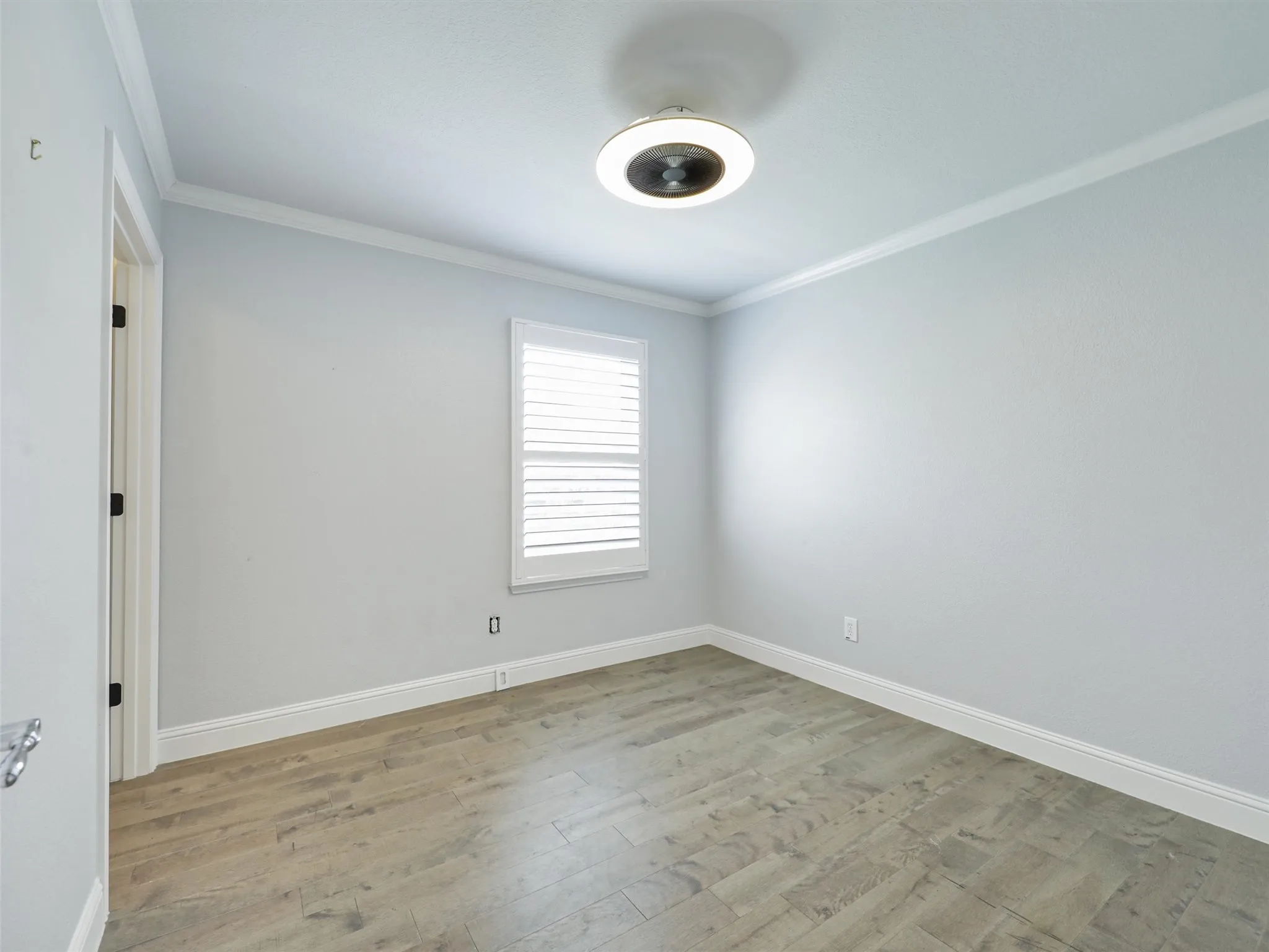 Second Bedroom room with updated lighting, LVP Flooring and crown molding