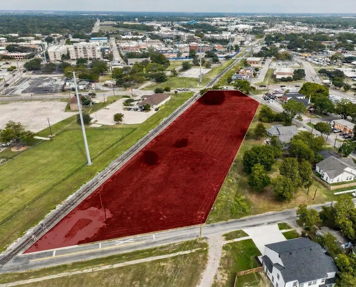 Expansive land parcel with direct road frontage and rail line adjacency