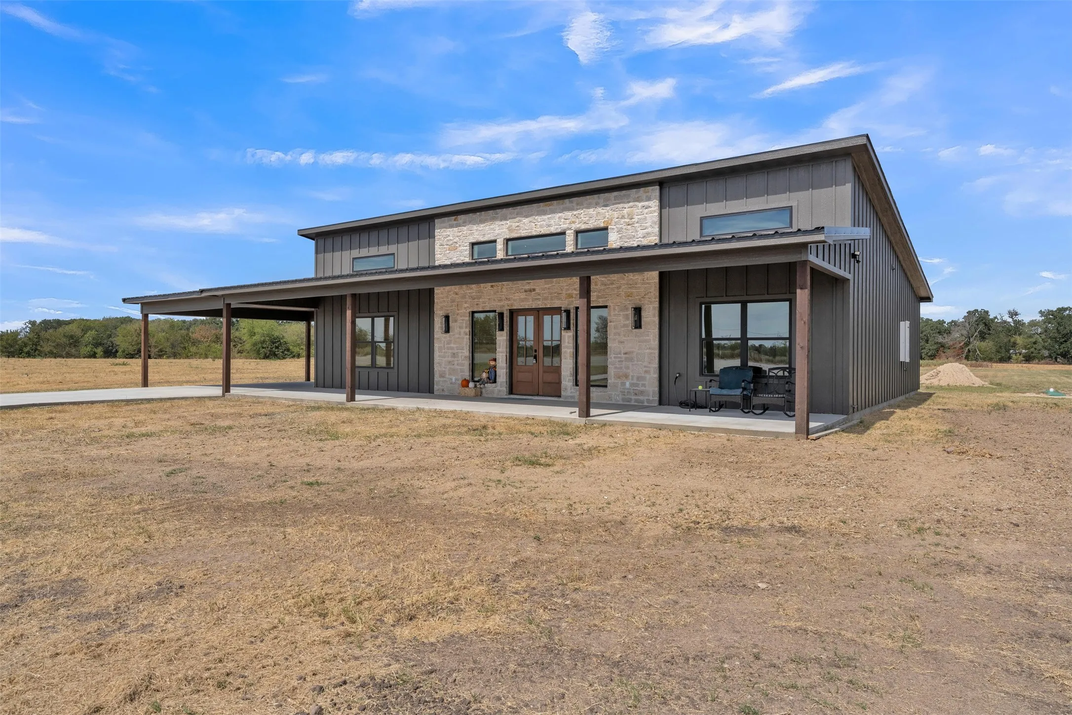 Modern barn-style exterior with vertical siding and stone accents