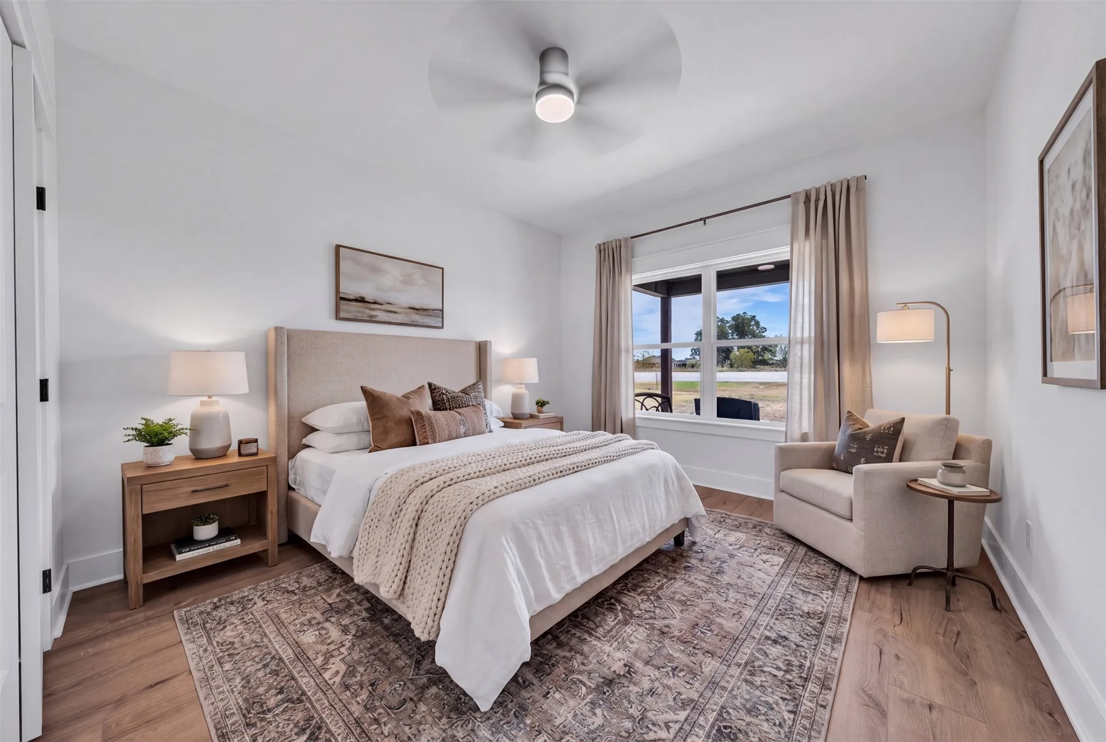 Wood-finish flooring, white walls, large window, ceiling fan, and recessed lighting
