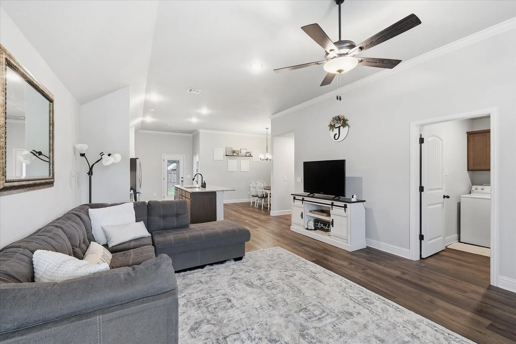 Spacious living area featuring wood-finish flooring, recessed lighting, and a ceiling fan