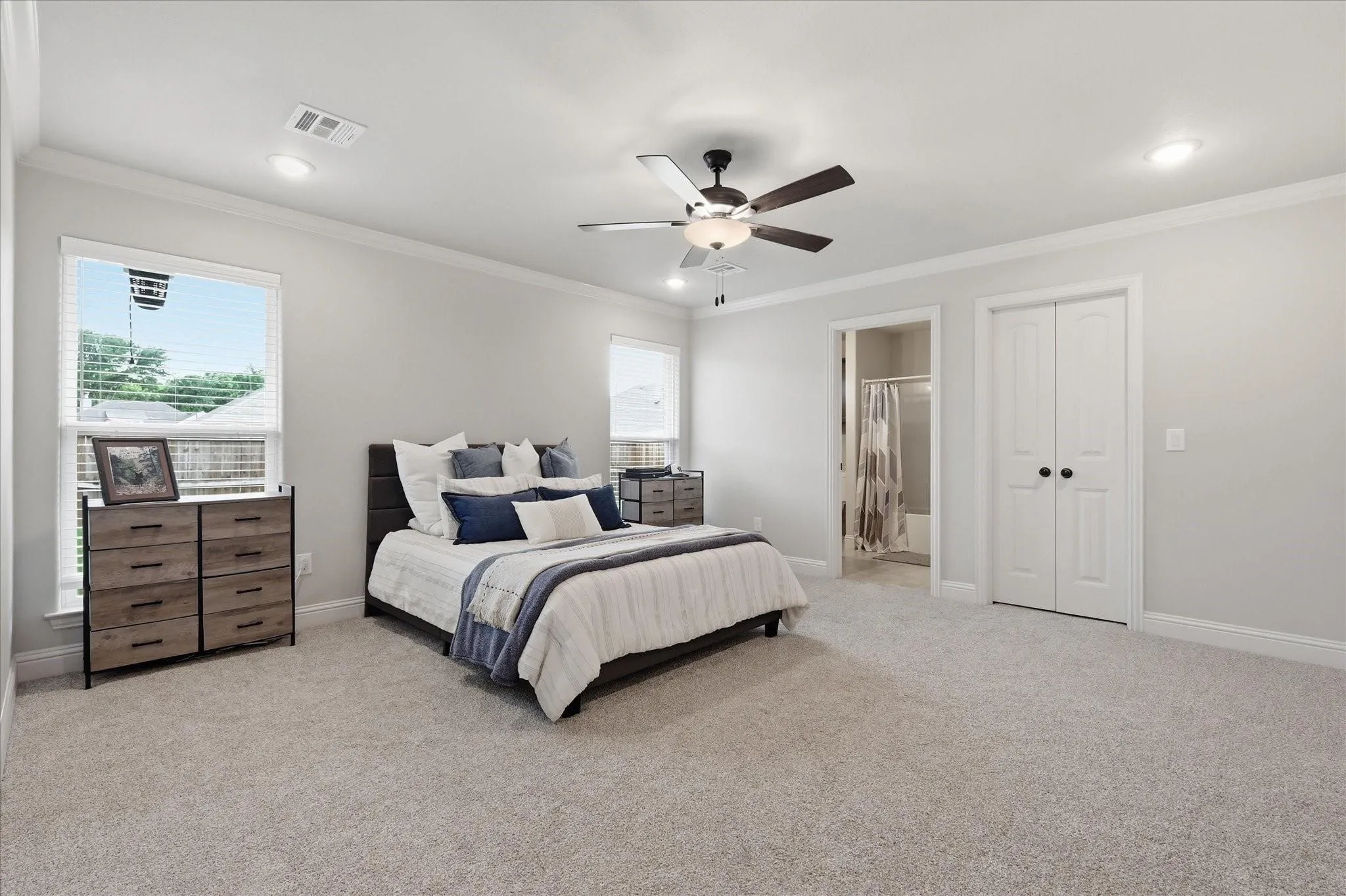Plush carpeting, recessed lighting, and a ceiling fan with integrated lighting