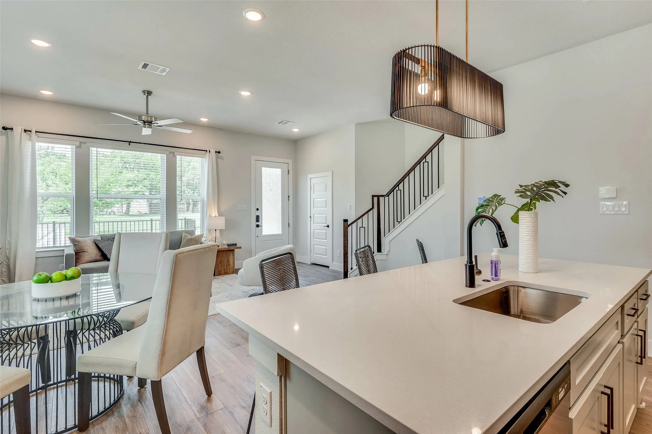 Kitchen island with a stainless steel sink and matte black faucet