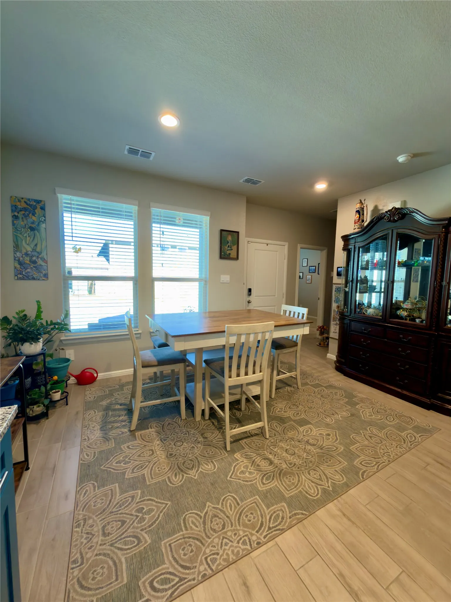 Dining area with recessed lighting and light wood finished floors