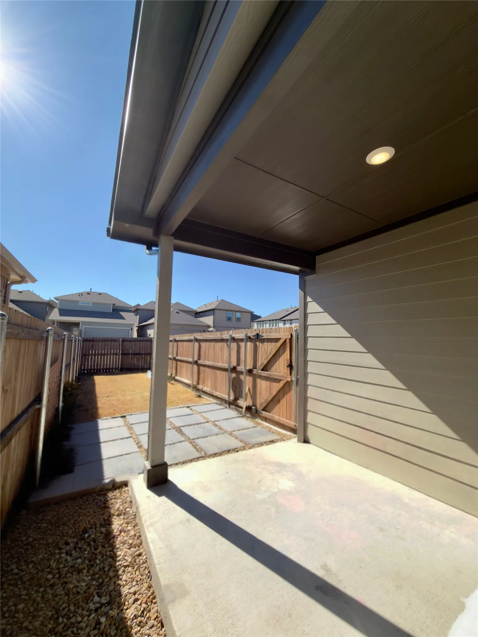Fenced backyard featuring a patio and a residential view