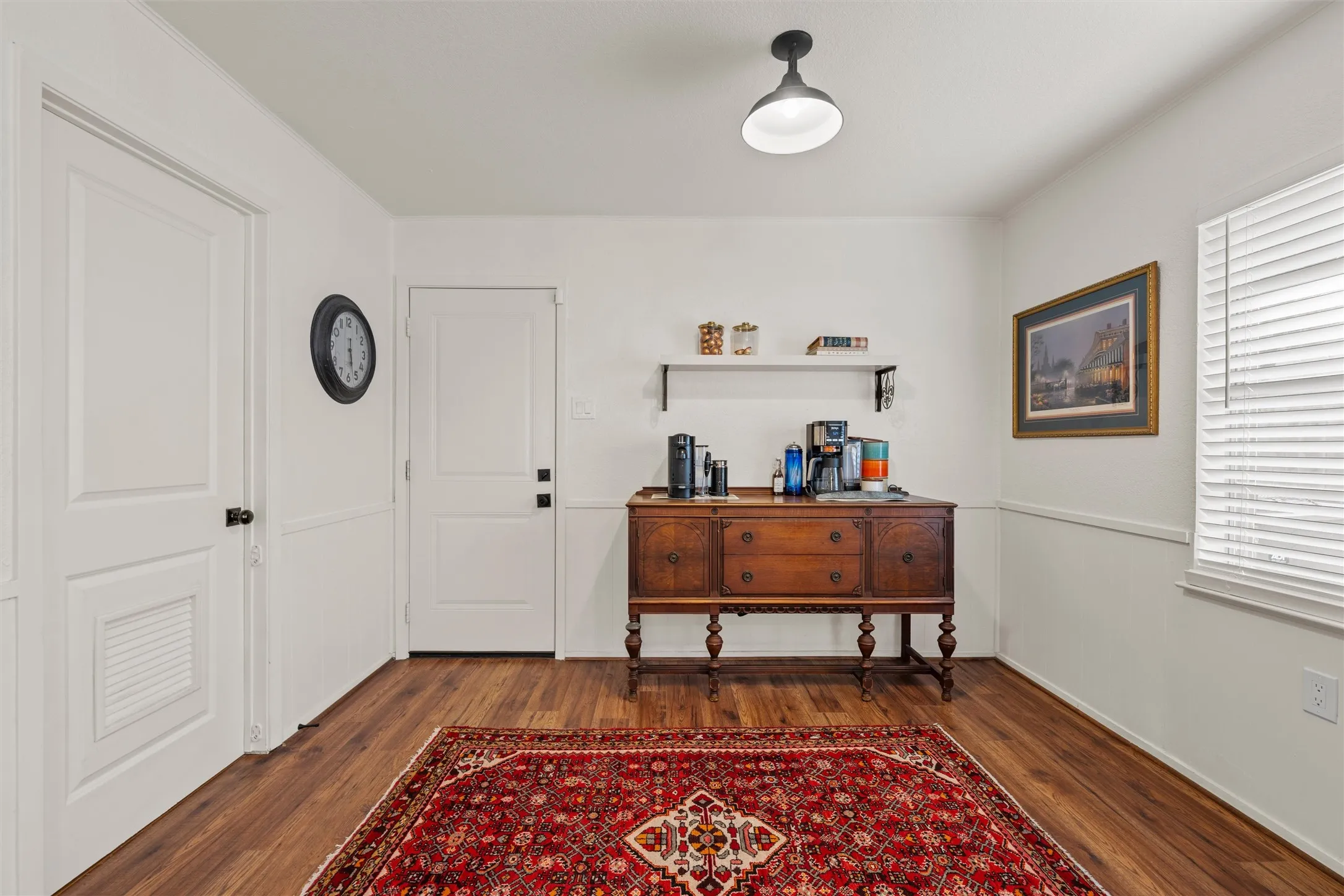 Wood-finish flooring with white wall paneling