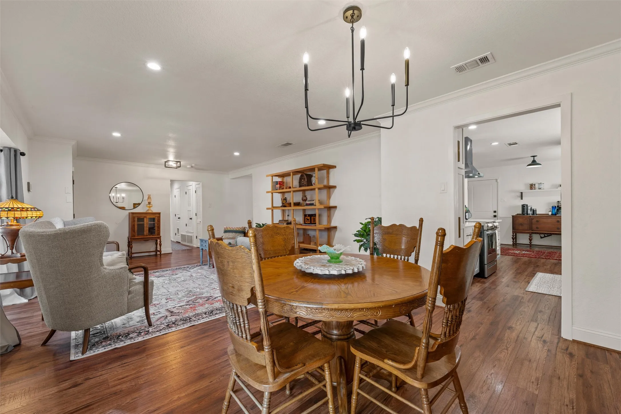 Wood-finish flooring throughout, with a recessed lighting array and crown molding