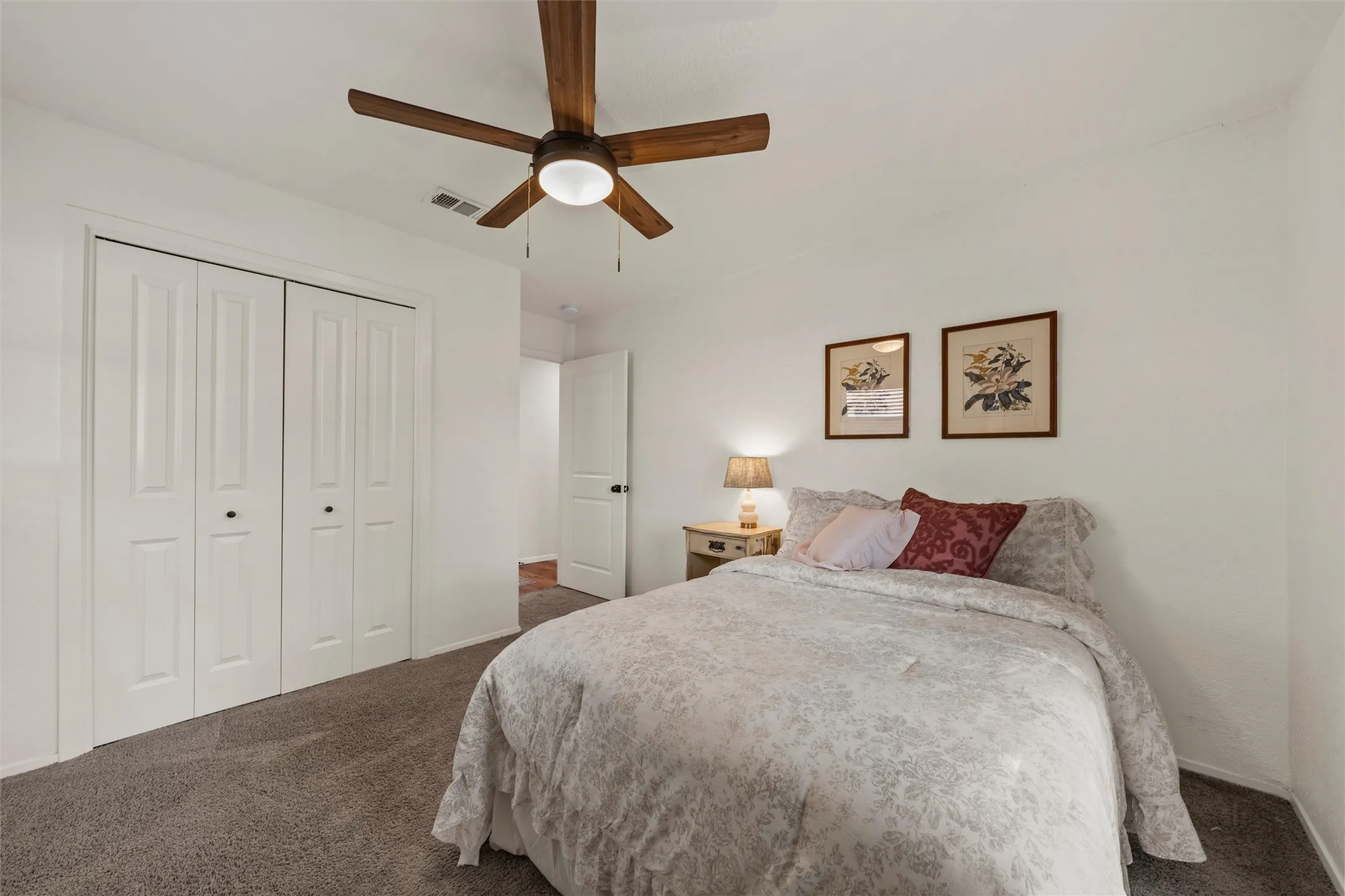 Room featuring neutral wall tones, bi-fold closet doors, and carpet flooring