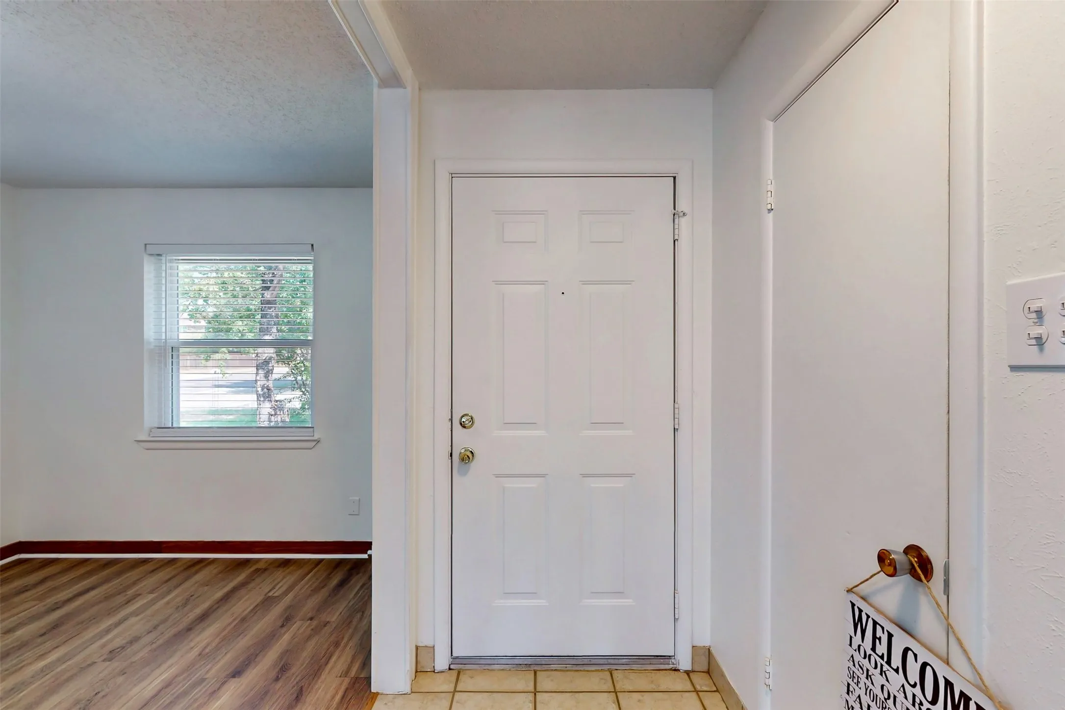 Main entry opens to formal dining and living areas. Two coat closets provide storage--one near the front door and one at the opposite end of the hall.