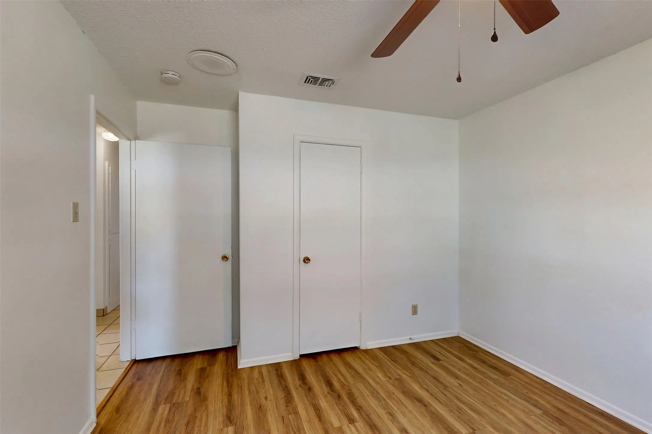 Bedroom 2 has a walk-in closet and wood-look luxury vinyl plank flooring.