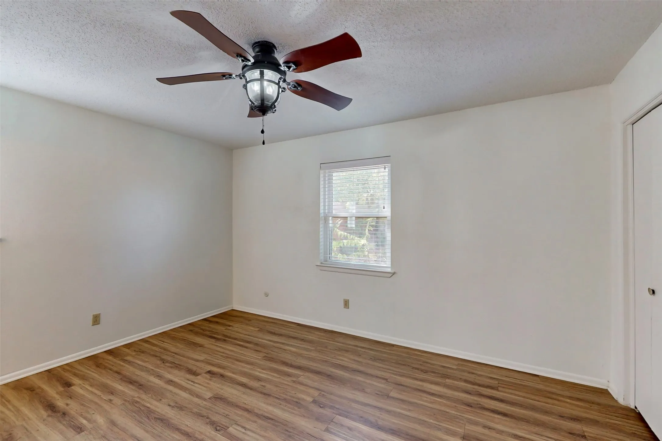 The primary bedroom has a view of the backyard. All bedrooms have updated window blinds.