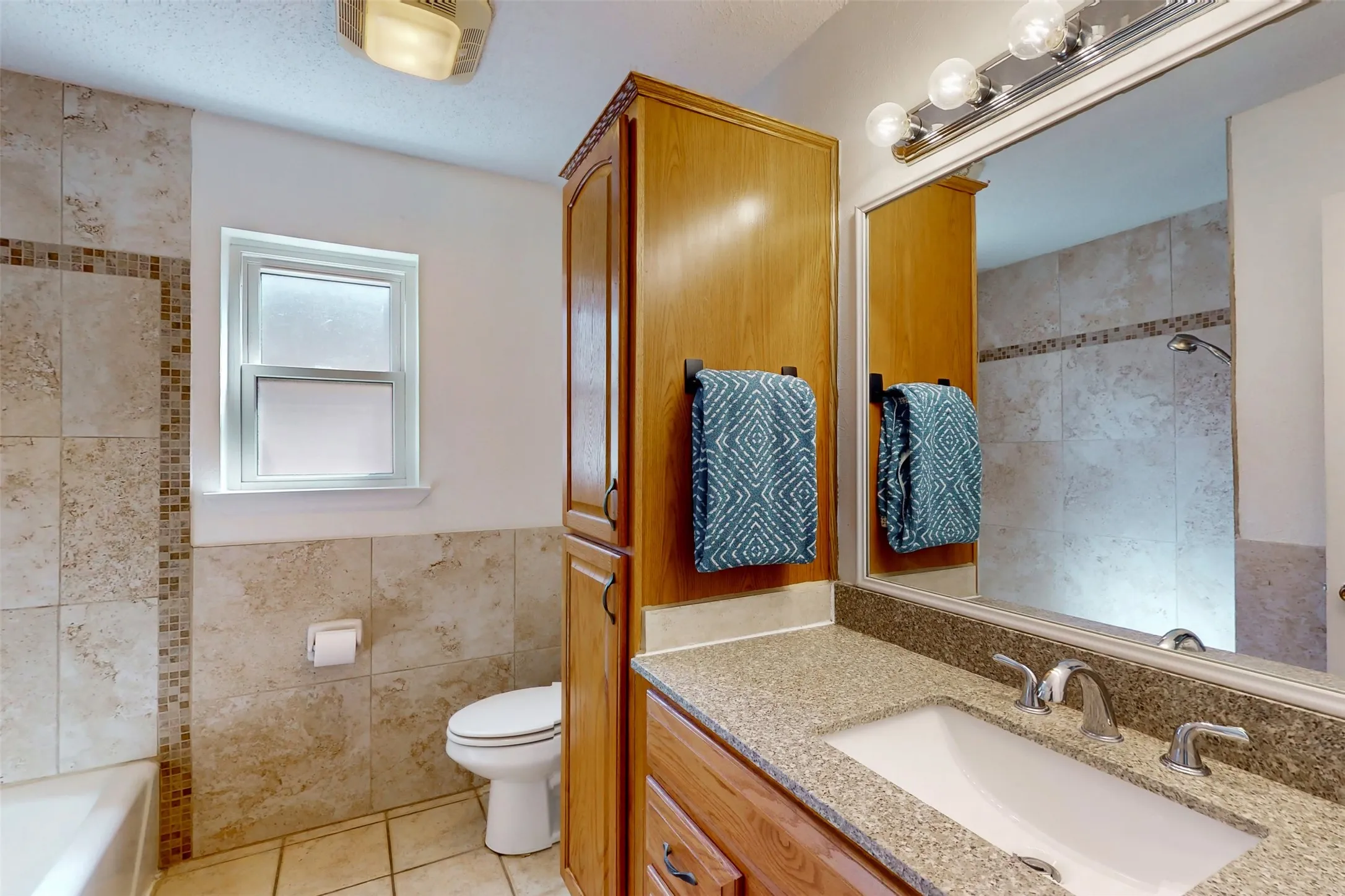 Hall bathroom not only has a built-in storage vanity, but also a large linen cabinet!
