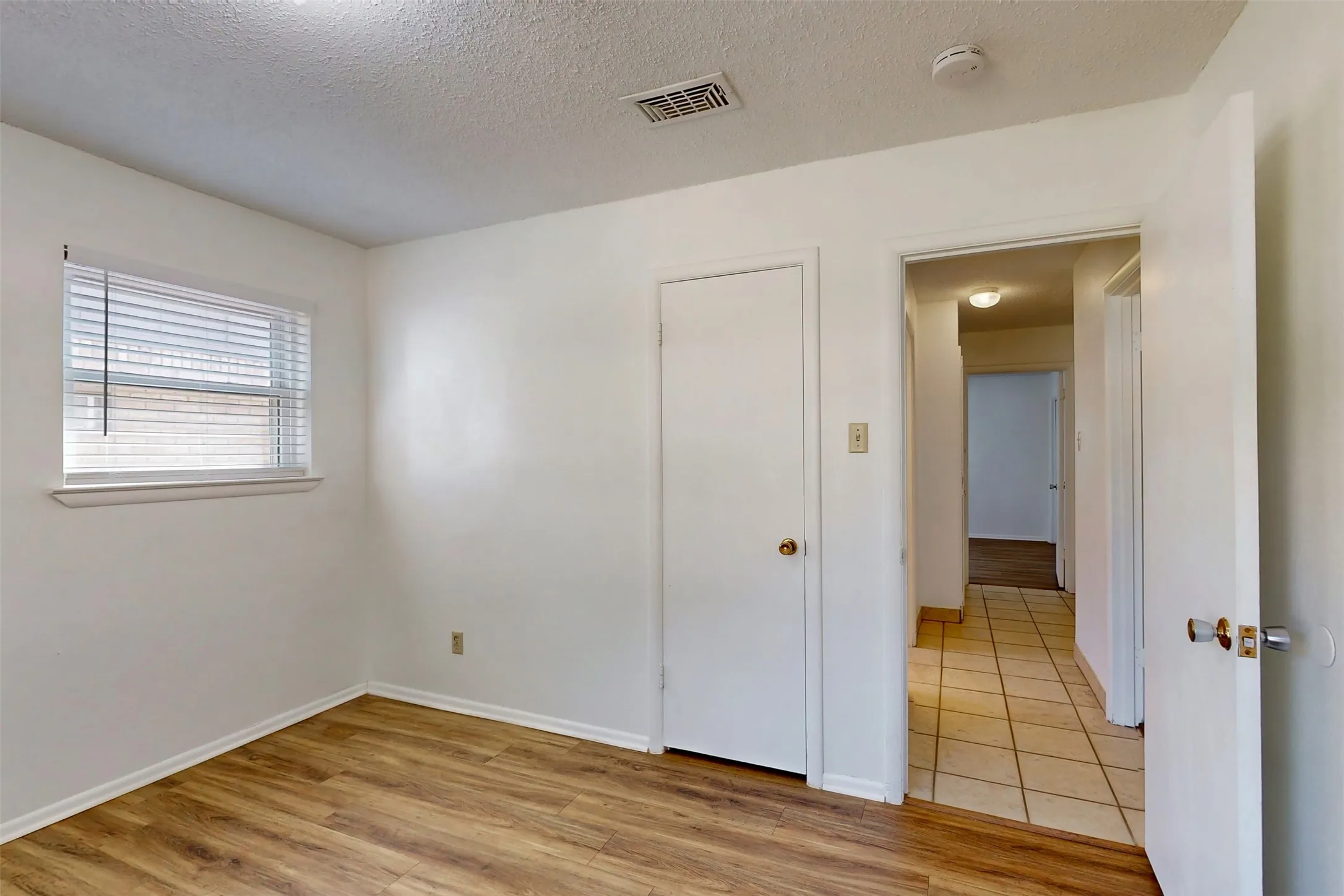 Bedroom 3 has it's own closet, window blinds, and wood-look luxury vinyl plank flooring.