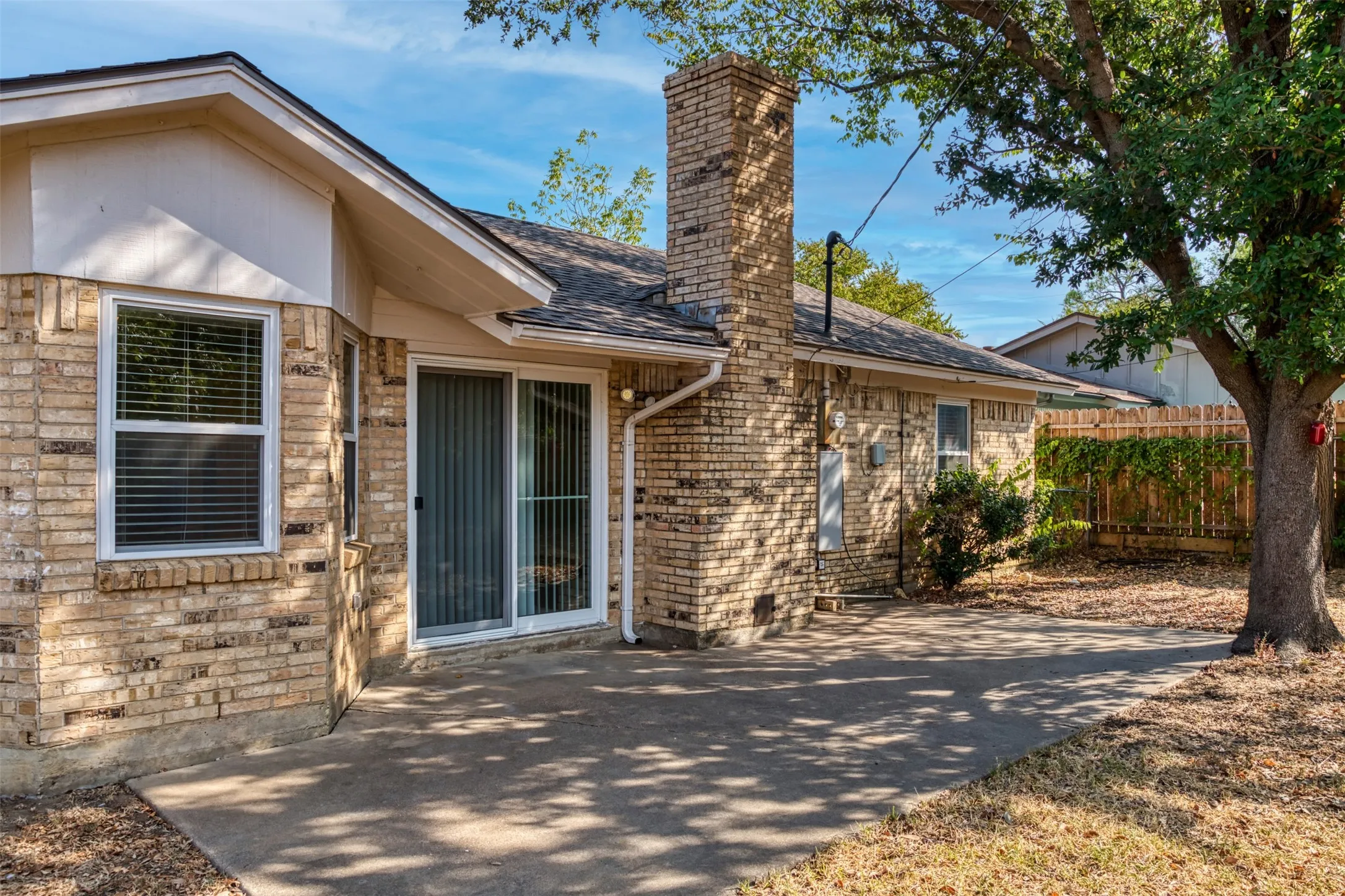 Relax and enjoy the shade provided by mature trees in the backyard.