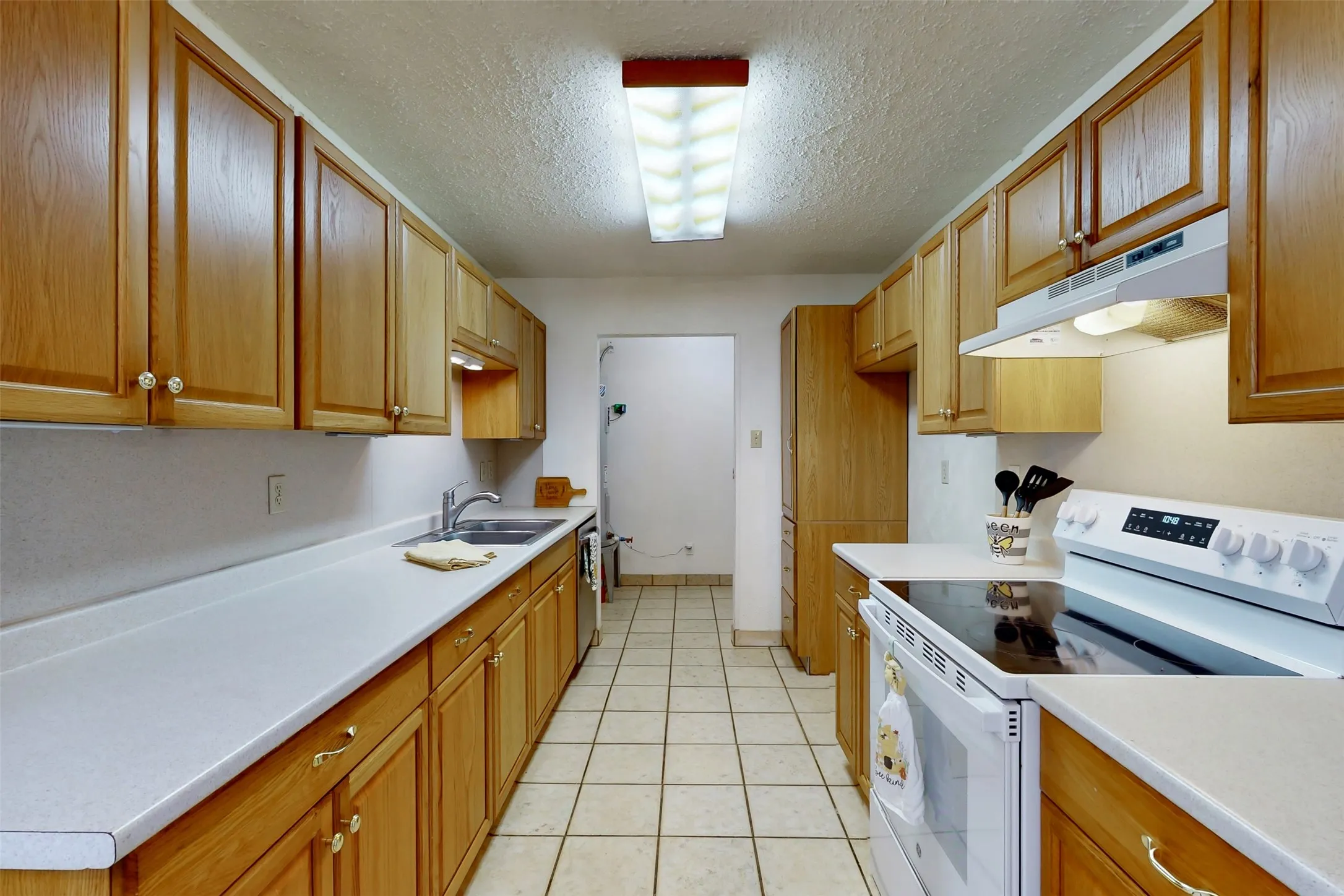 Everything is within reach in this kitchen, complete with a separate utility room!