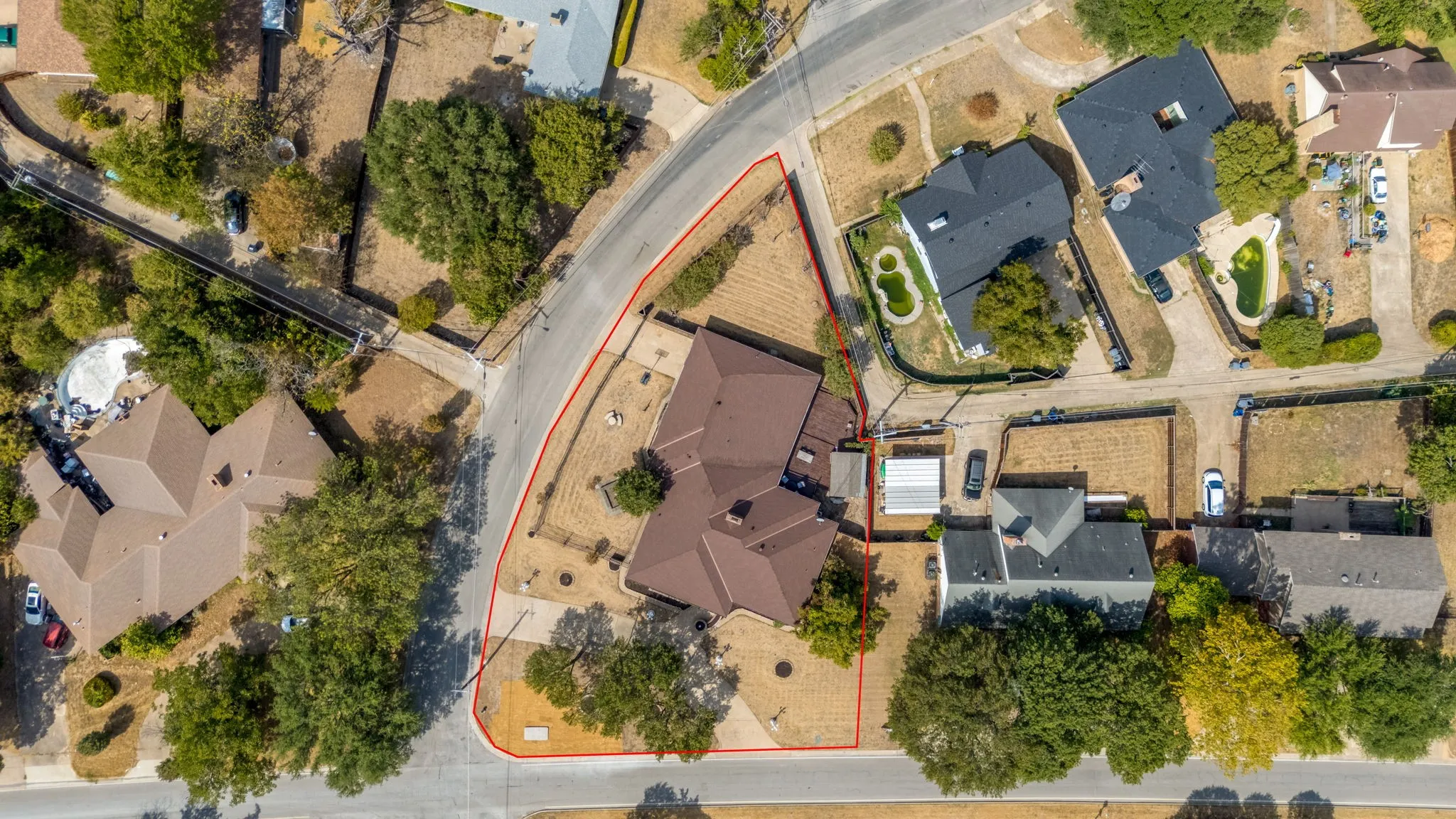 Single-story residence with a brown shingle roof situated on a corner lot