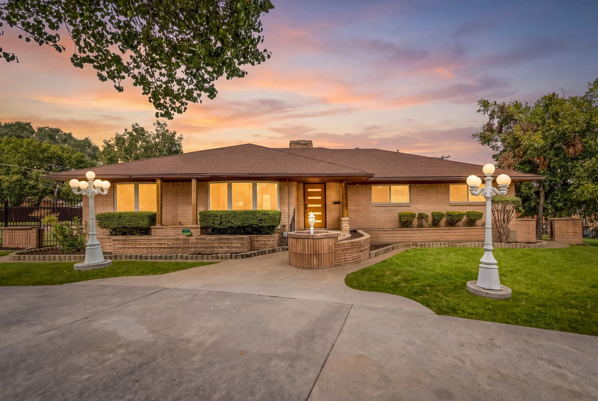 Brick exterior with a brown roof and a concrete driveway