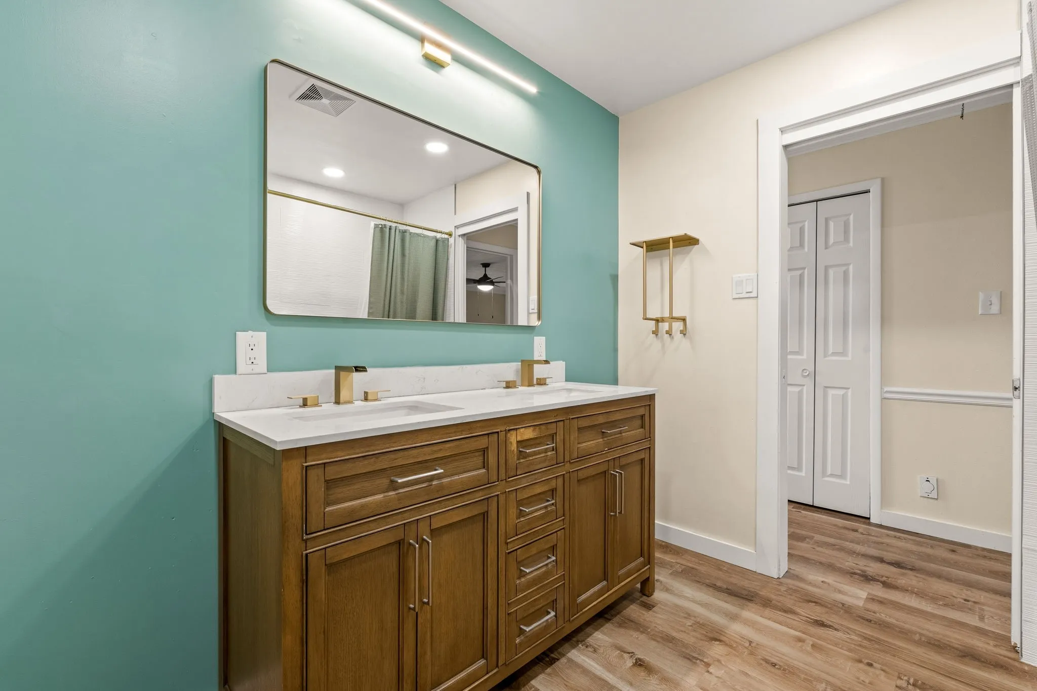 Double vanity with gold-toned fixtures and white countertop