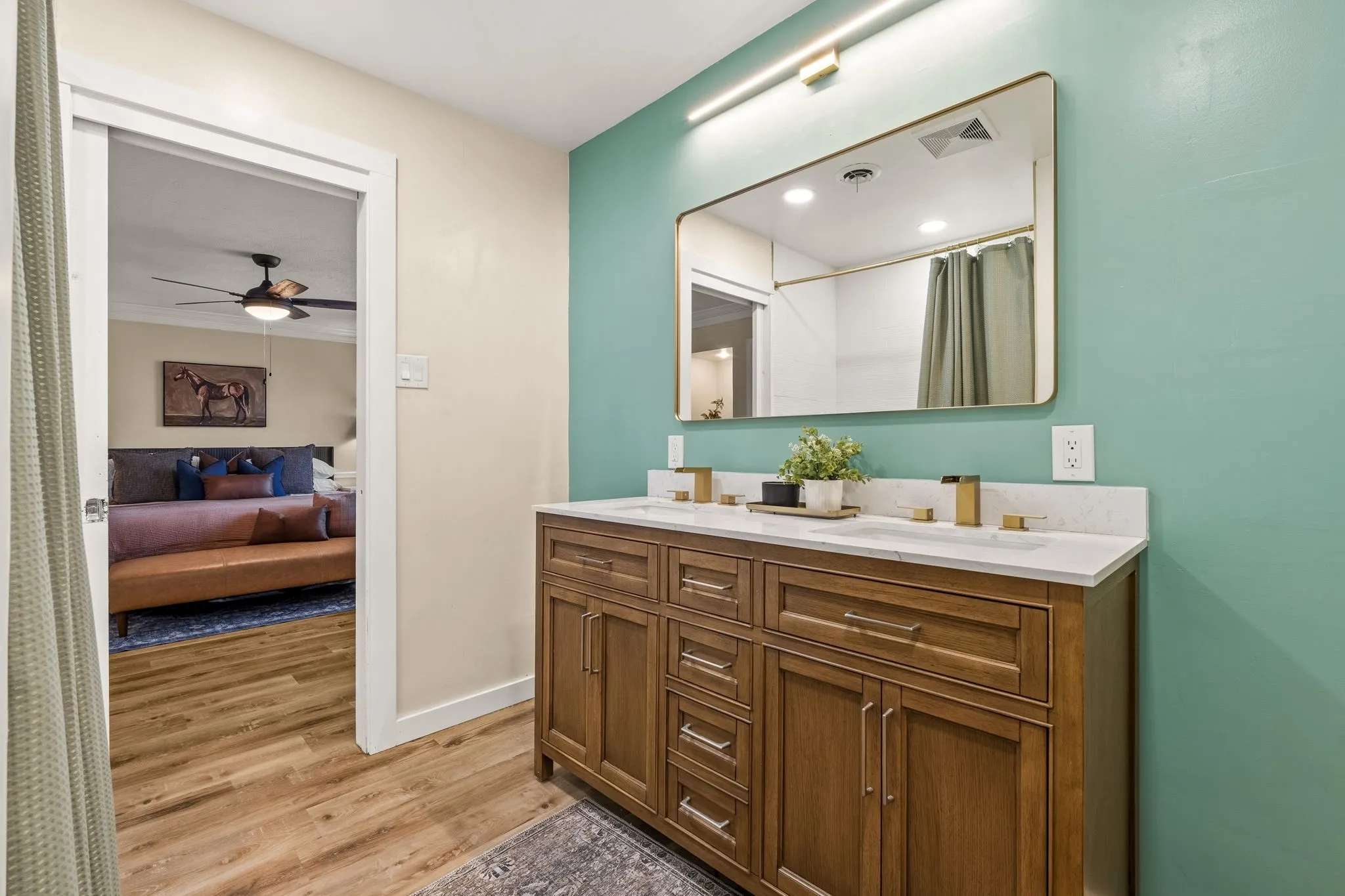 Dual vanity with white countertop, undermount sinks, and gold-finish faucets