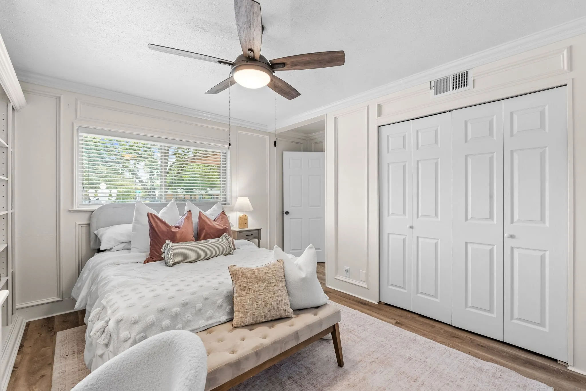 Wood-finish flooring with a ceiling fan light fixture