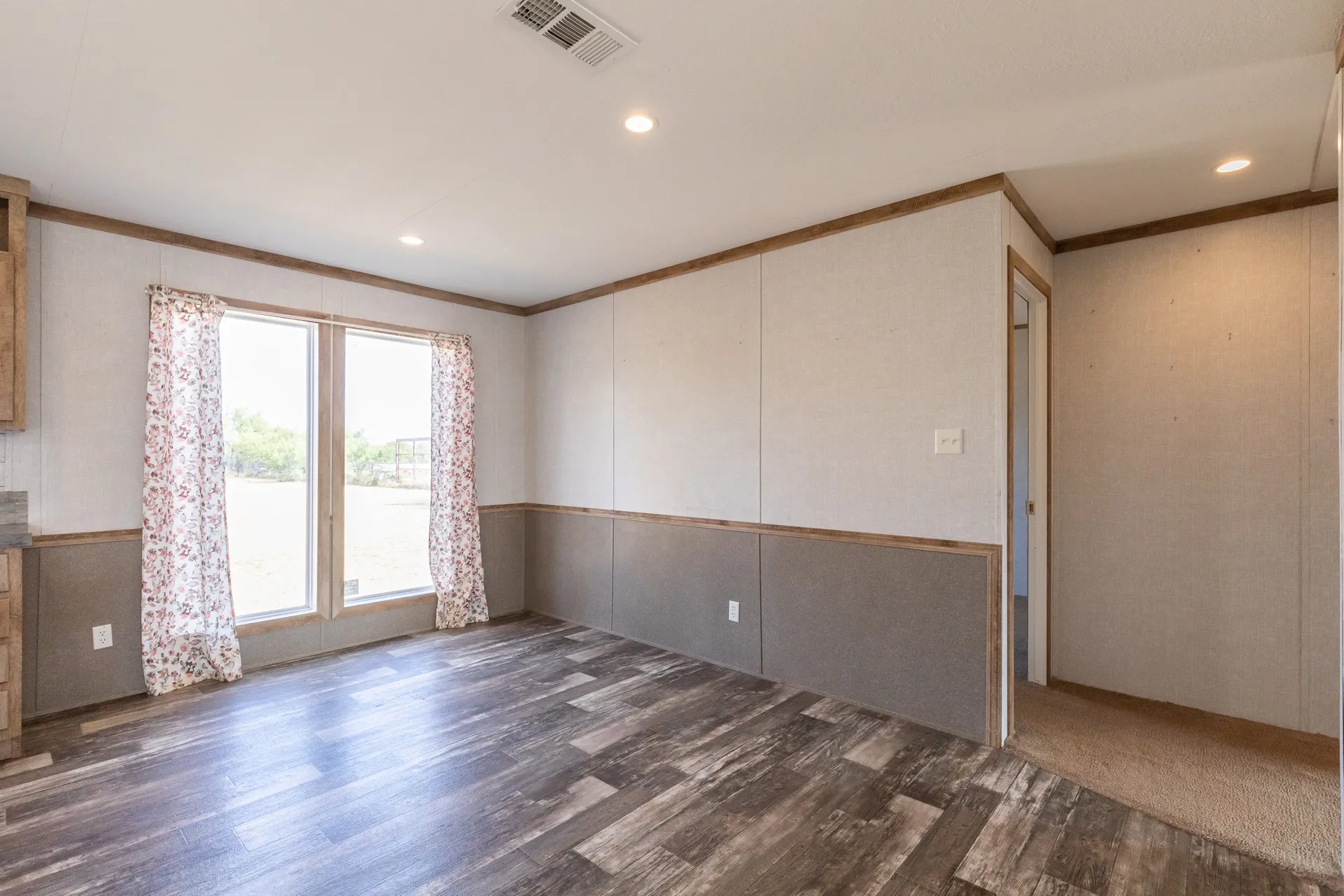 Wood-finish flooring, recessed lighting, and dual windows