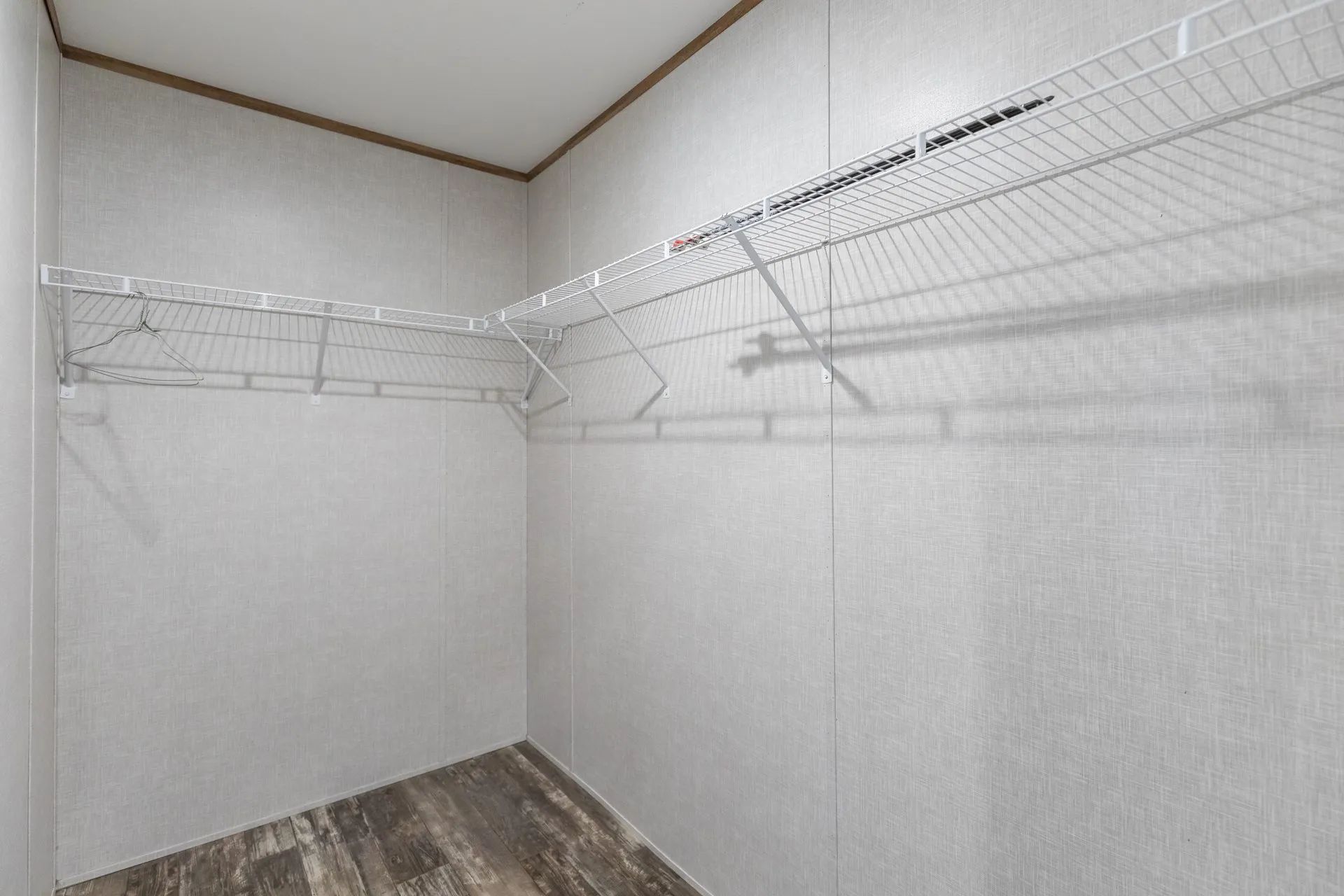 White wire shelving, wood-finish flooring