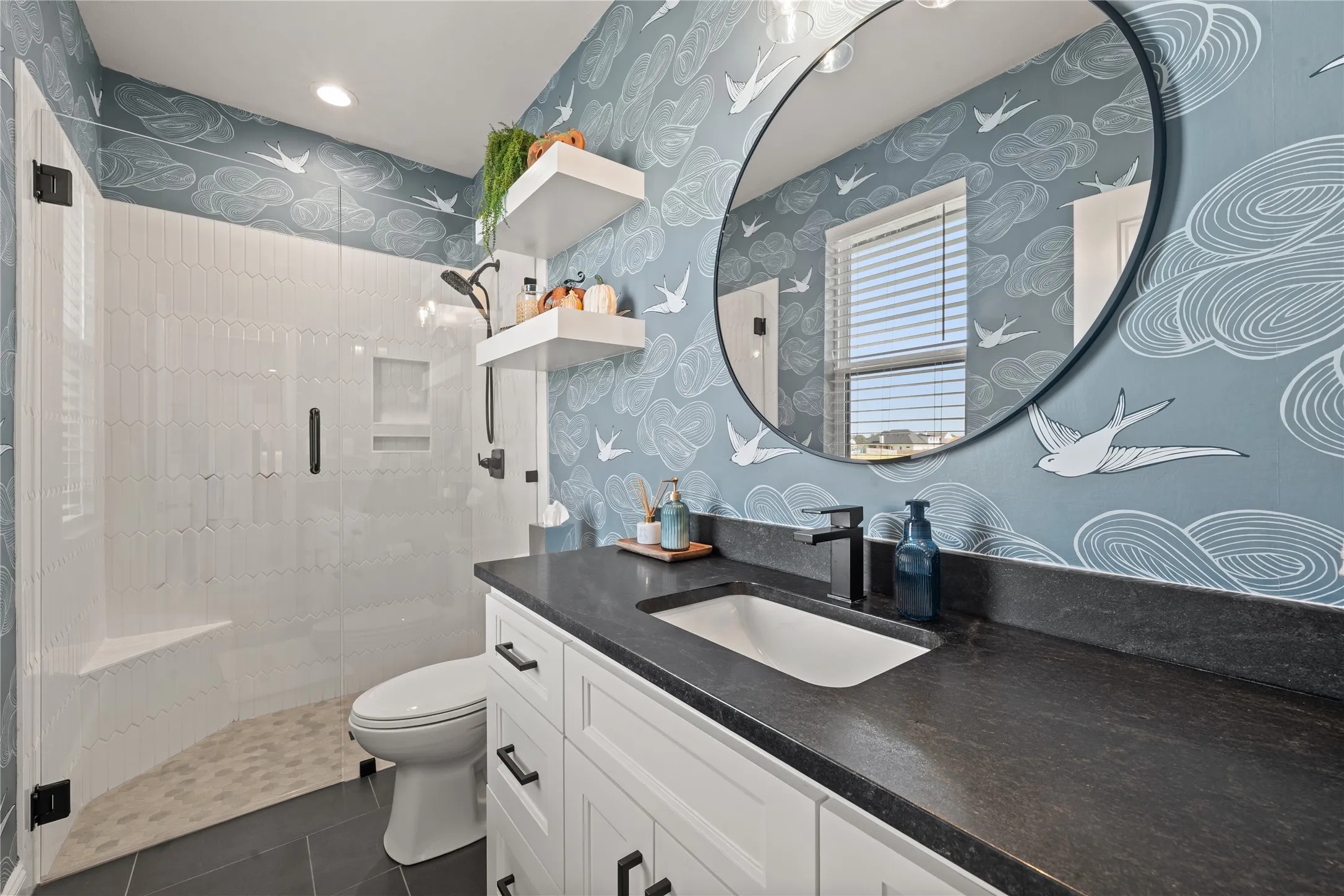 Walk-in shower with clear glass enclosure and integrated bench