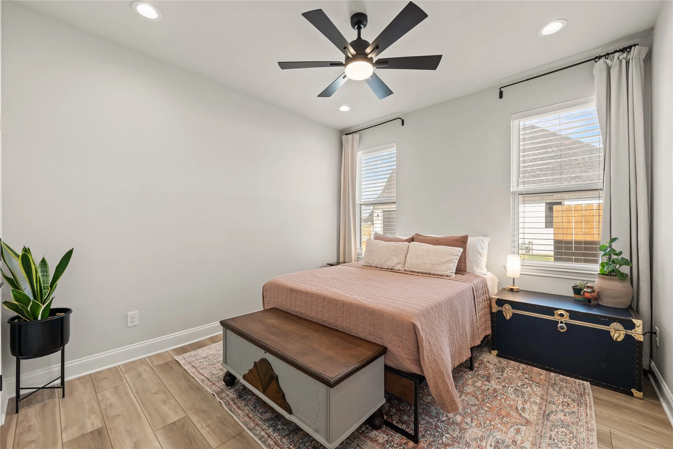 Wood-finish flooring throughout, recessed lighting, and a ceiling fan with integrated lighting
