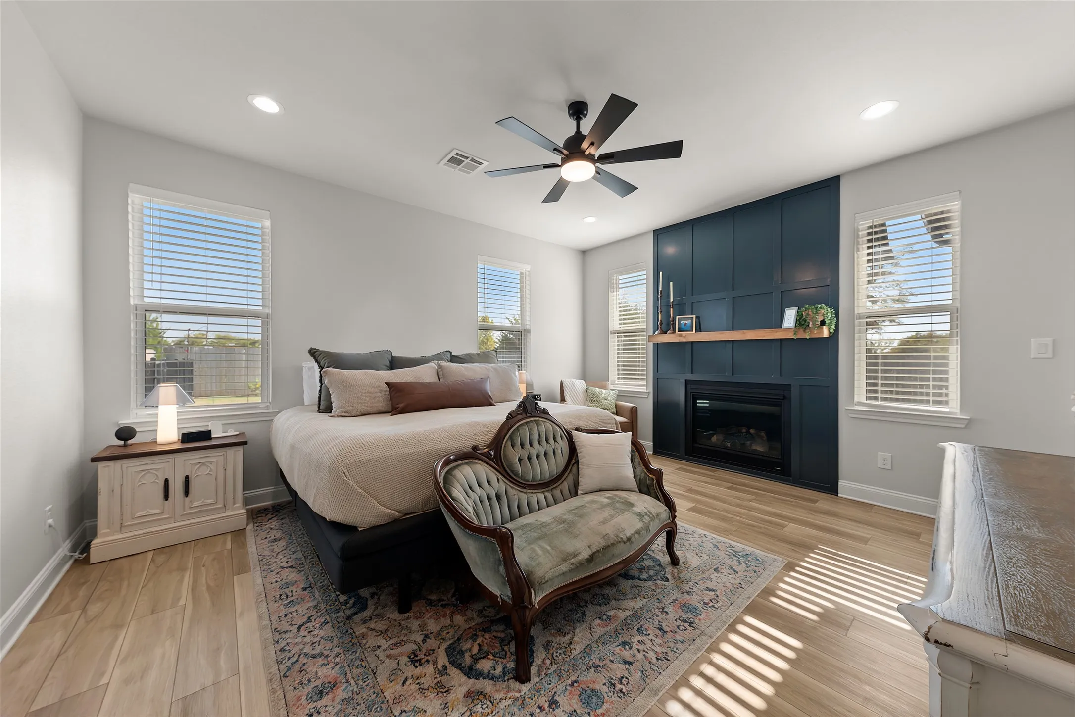 Recessed lighting, wood-finish flooring, and a ceiling fan with integrated lighting
