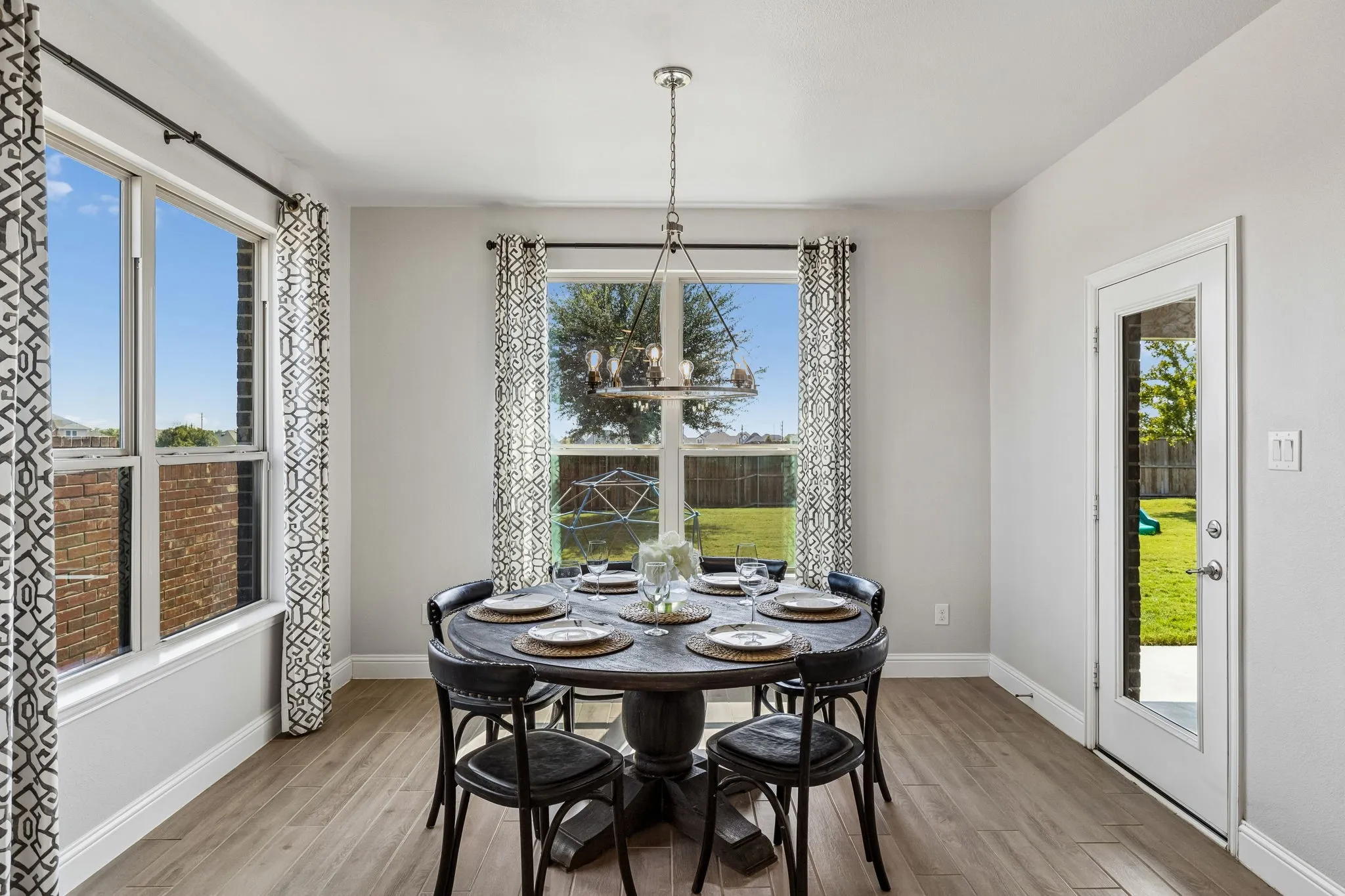 The large breakfast area offers a beautiful place to eat casual meals with easy access to the backyard.