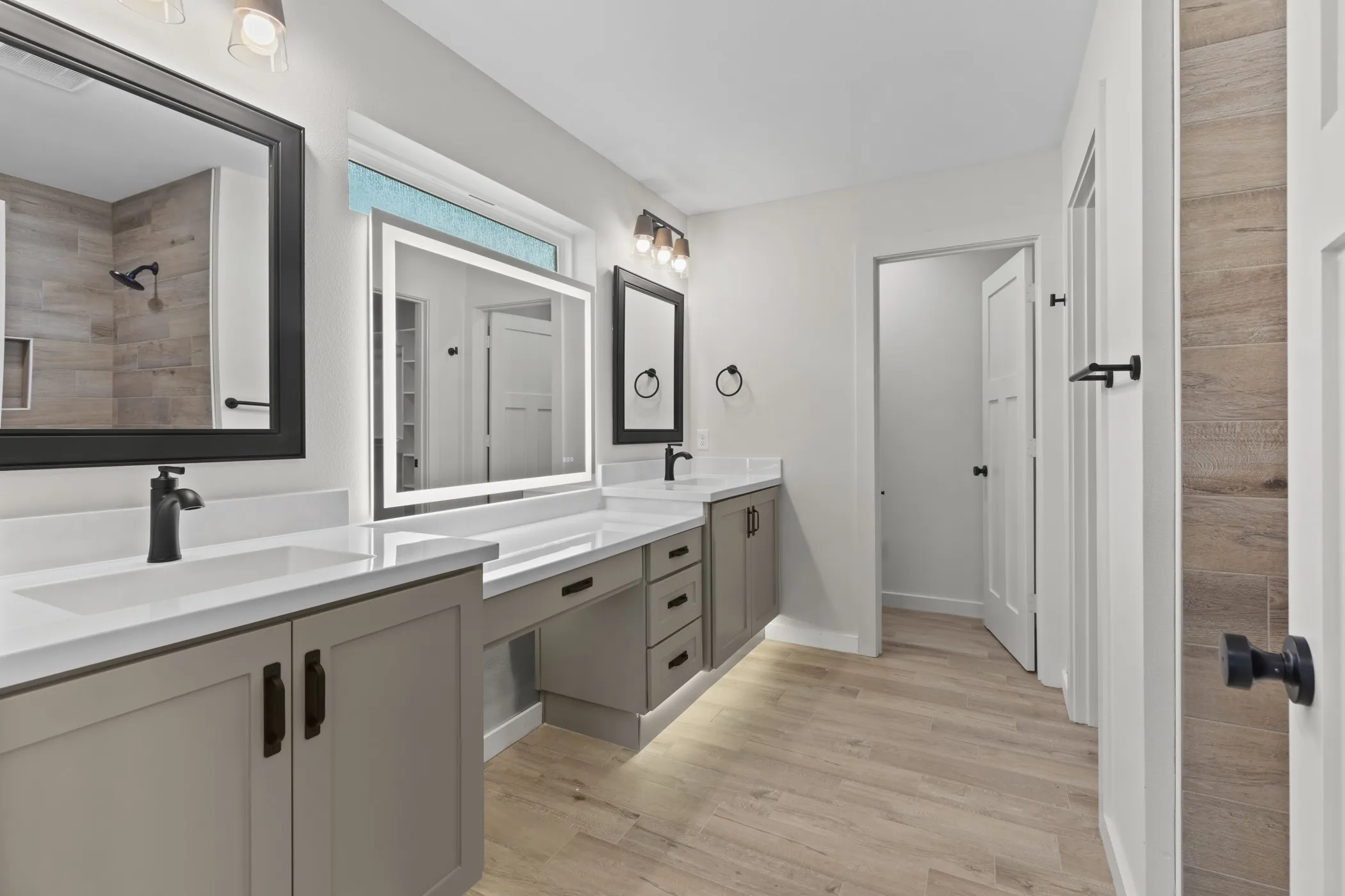 Dual vanity with integrated sinks, quartz countertops, and matte black hardware